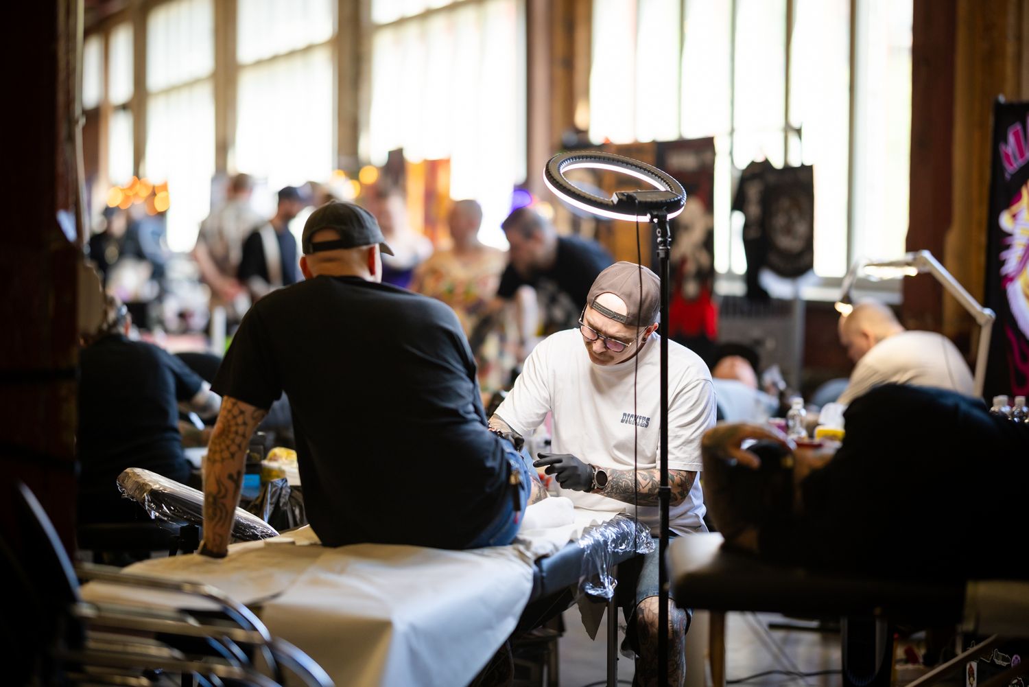 Tatuointiartisti tekemässä tatuointia asiakkaalle