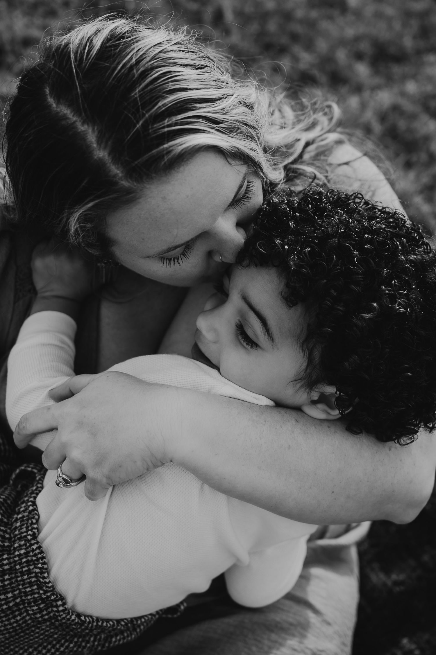 A tender black and white photo series showing intimate embraces and kisses between a couple in love.