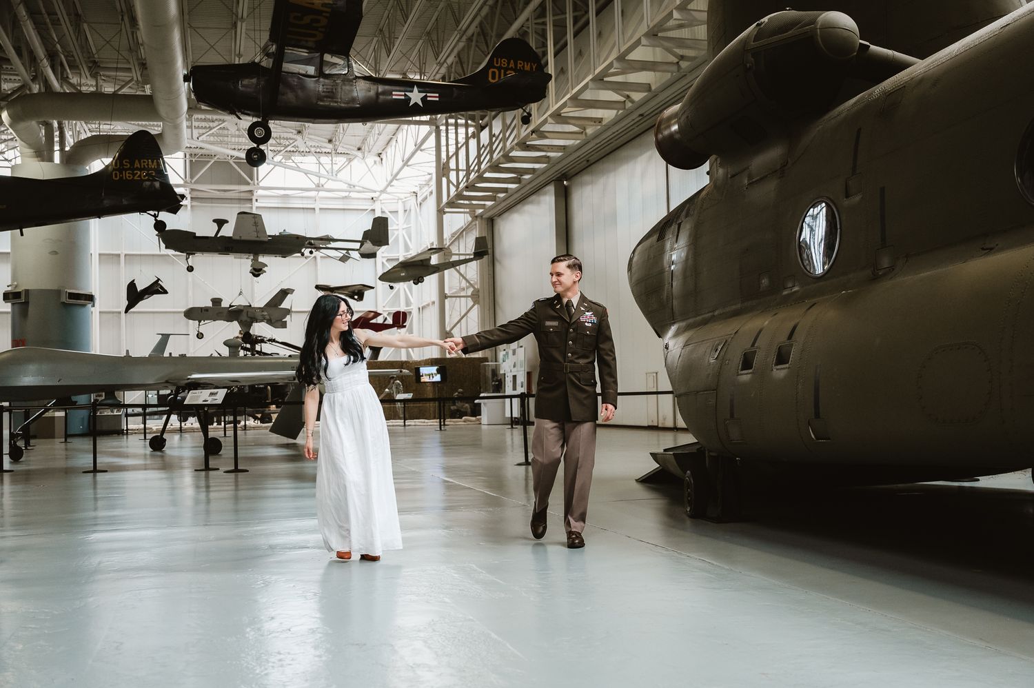 A series of four photographs showing a couple's wedding portraits taken inside an aviation museum with vintage aircraft.