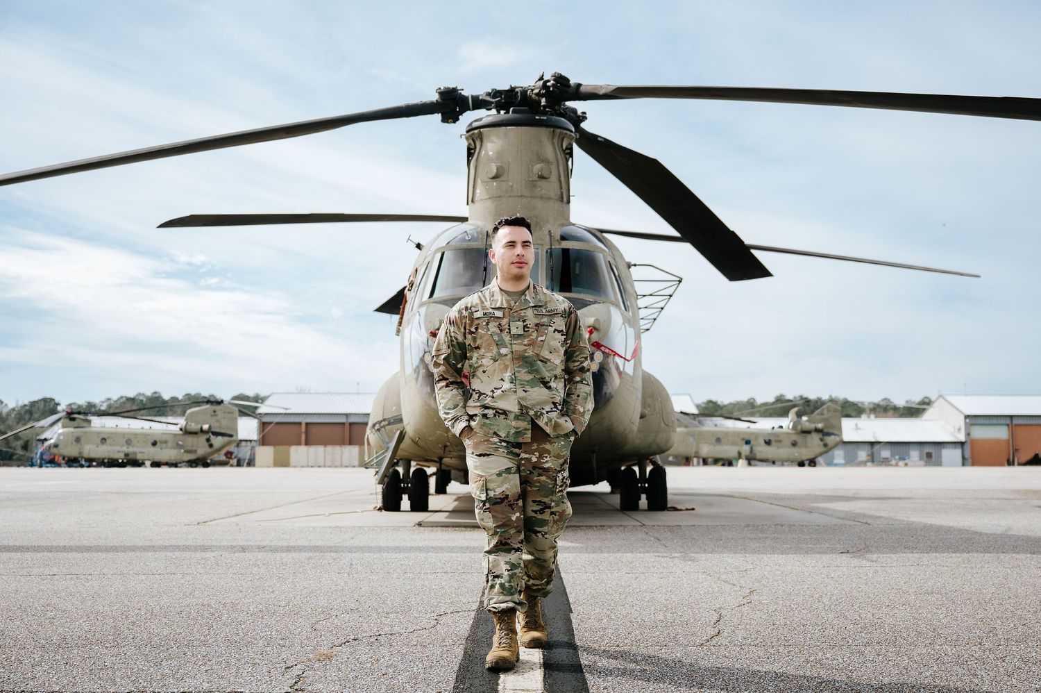 Military personnel and helicopters line up on an airfield during a deployment or training exercise.