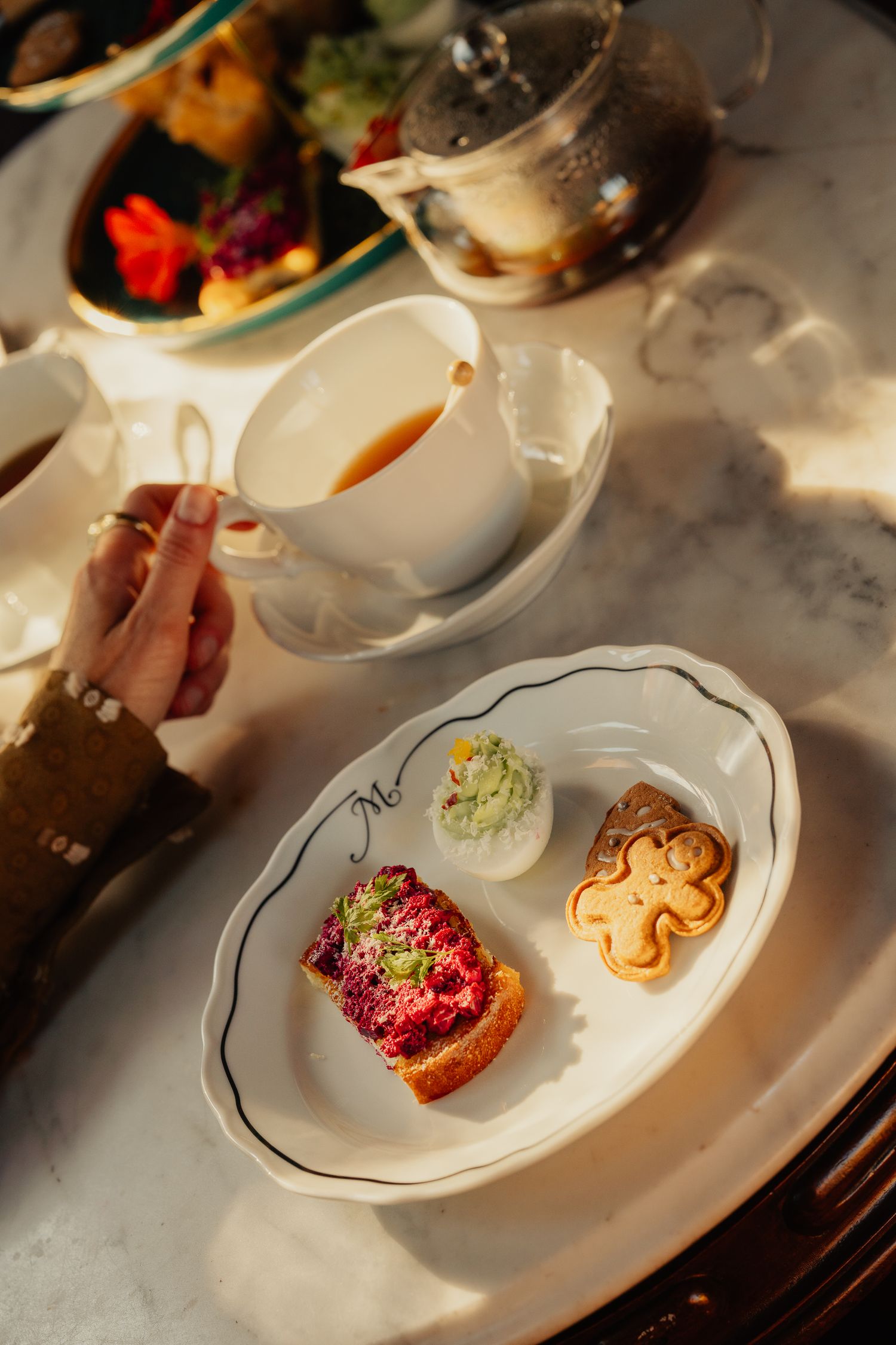 Plated desserts with colorful toppings and garnishes served on elegant white dishes in natural lighting.