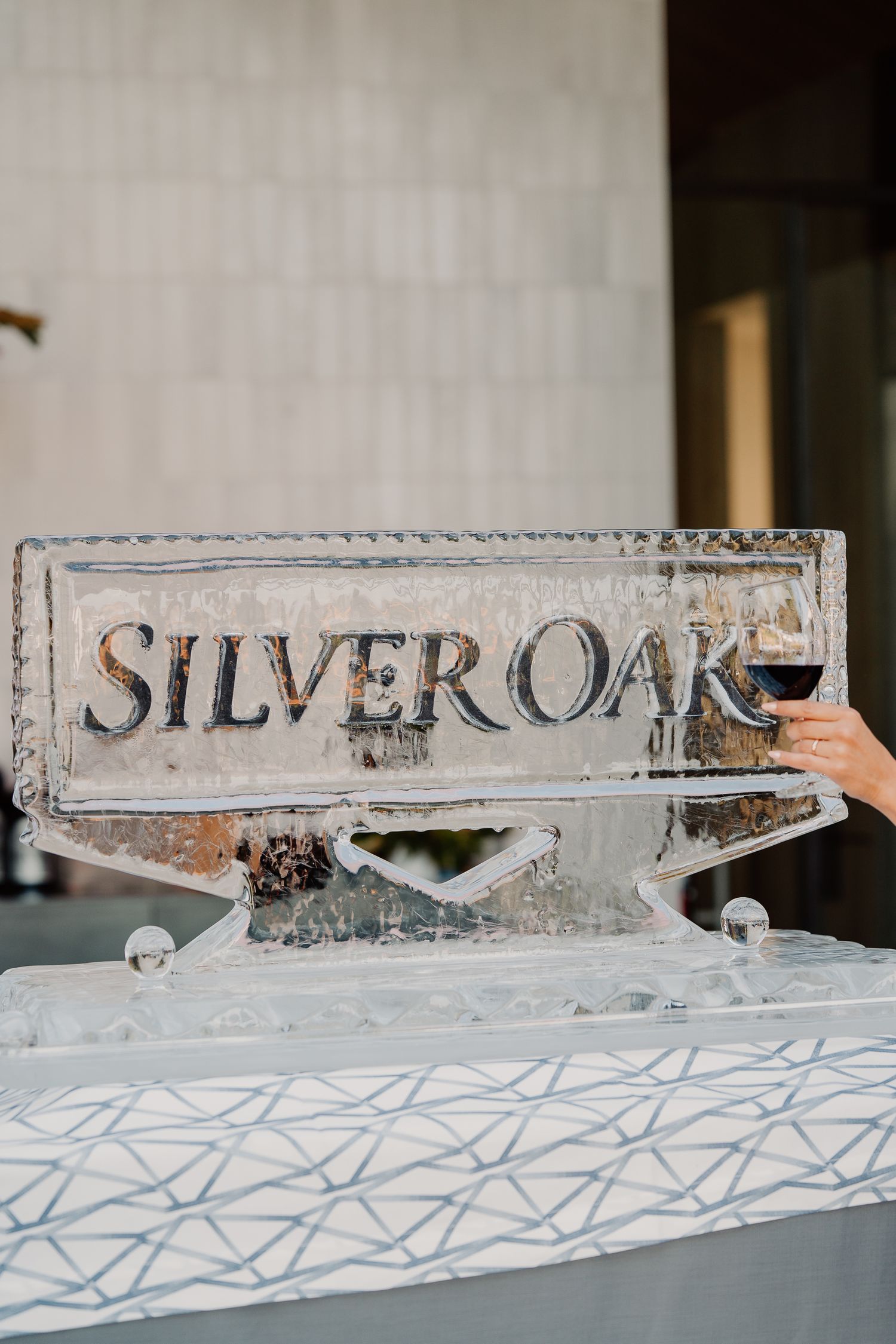 Silver Oak wine brand logo carved into a decorative ice sculpture at a winery event.