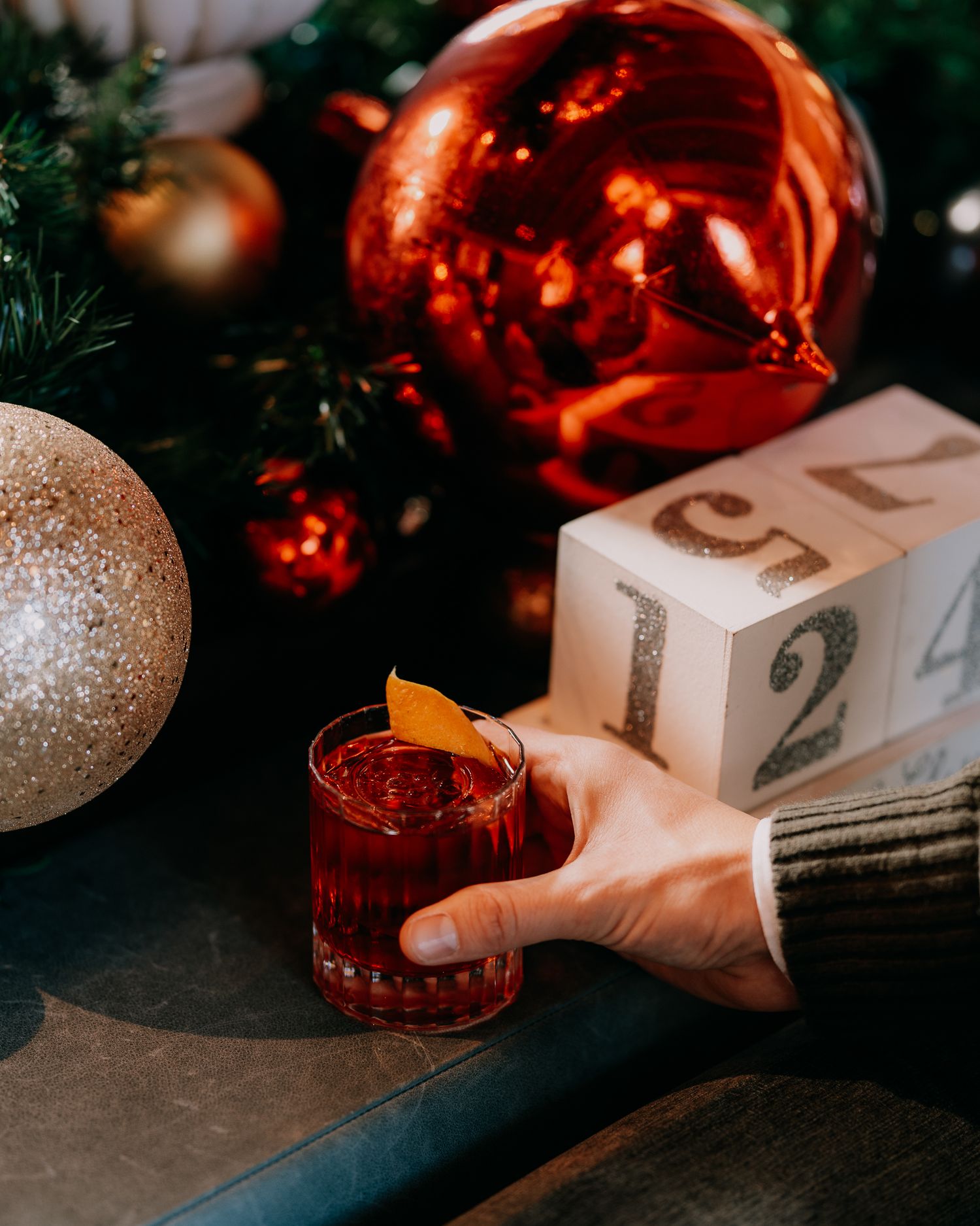 Glowing orange Christmas ornaments and white gift boxes create a festive holiday scene with warm ambient lighting.