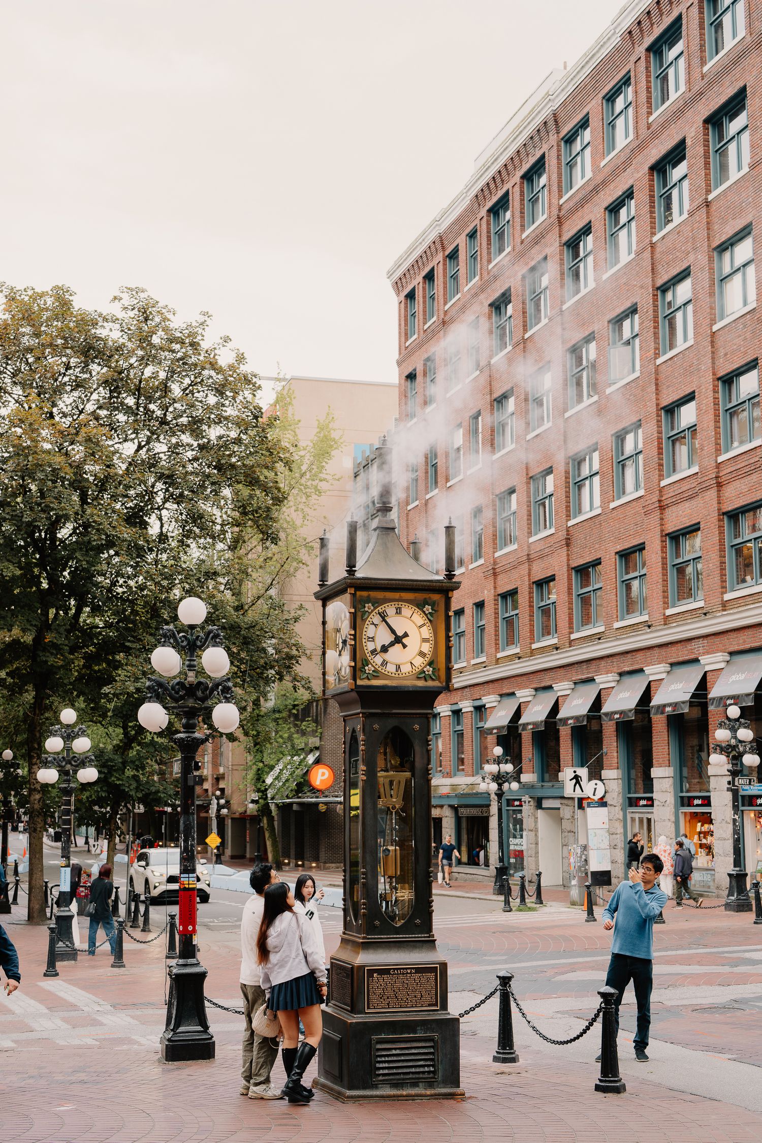 Five connected photos show a brick building facade with ornate street lamps and decorative details along a historic pedestrian area.