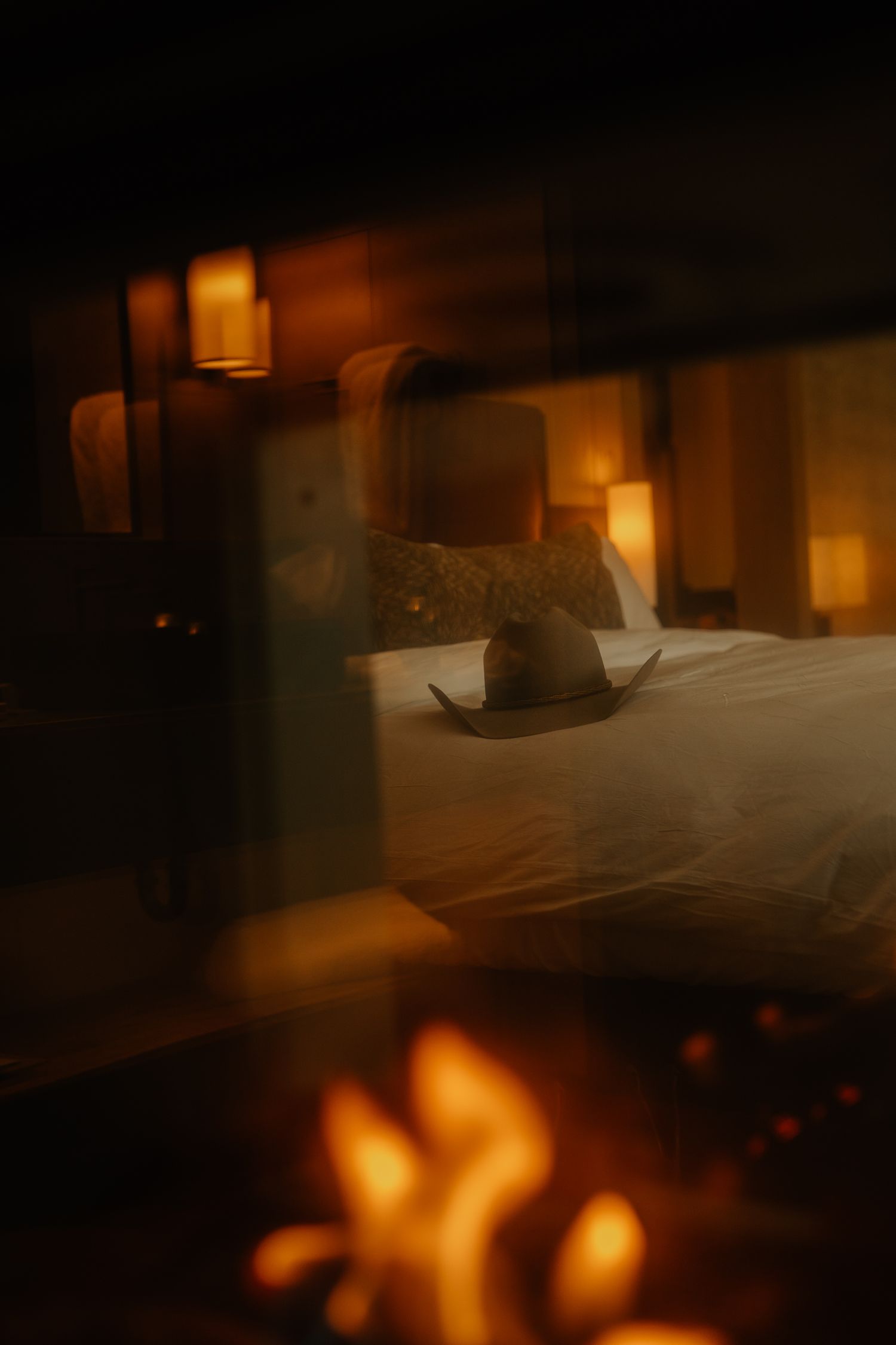 A dimly lit room with warm glowing candles or lanterns creating a cozy, atmospheric ambiance.