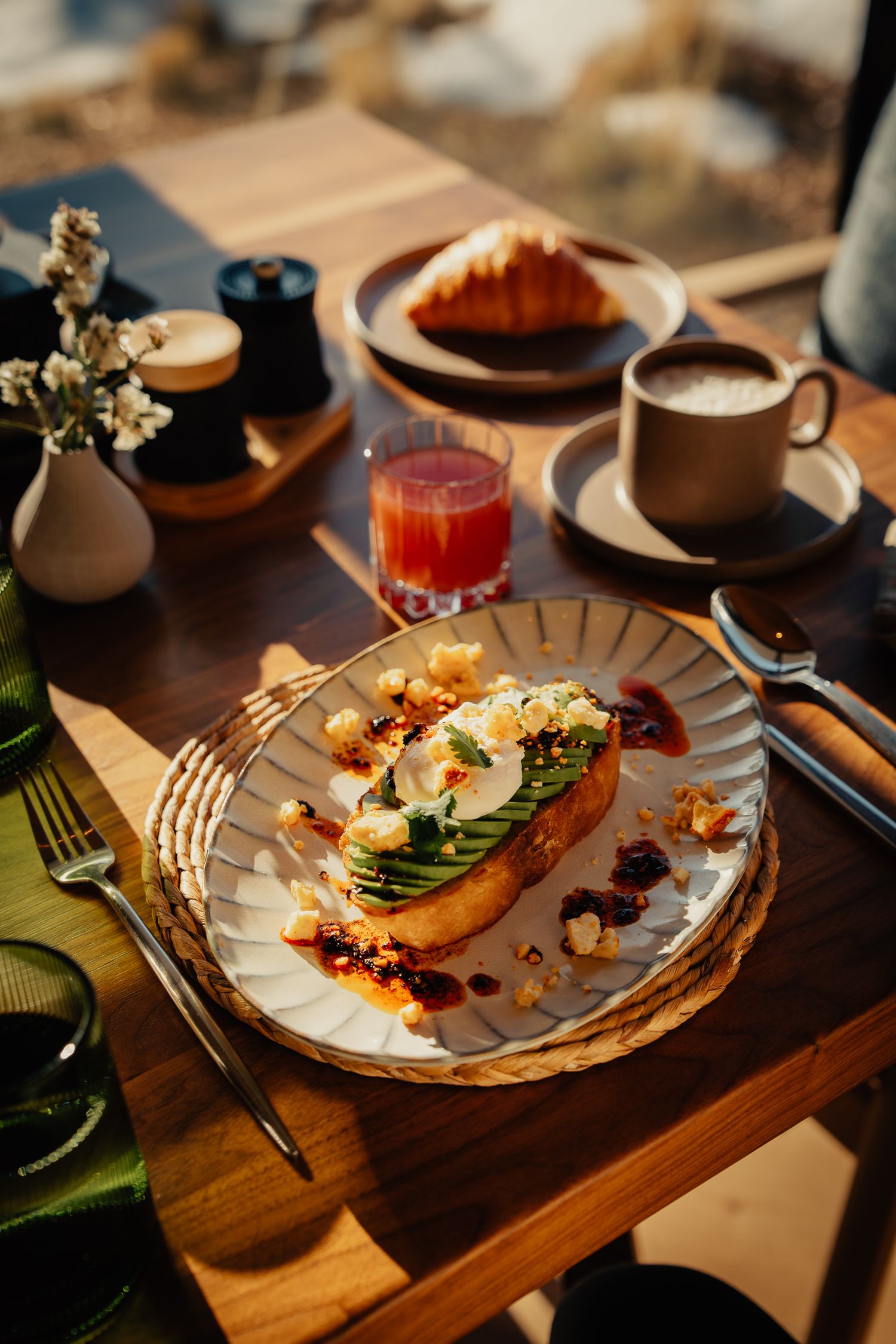 Elegant plated dishes on wooden tables showcase fine dining presentation with delicate garnishes and artistic arrangements.