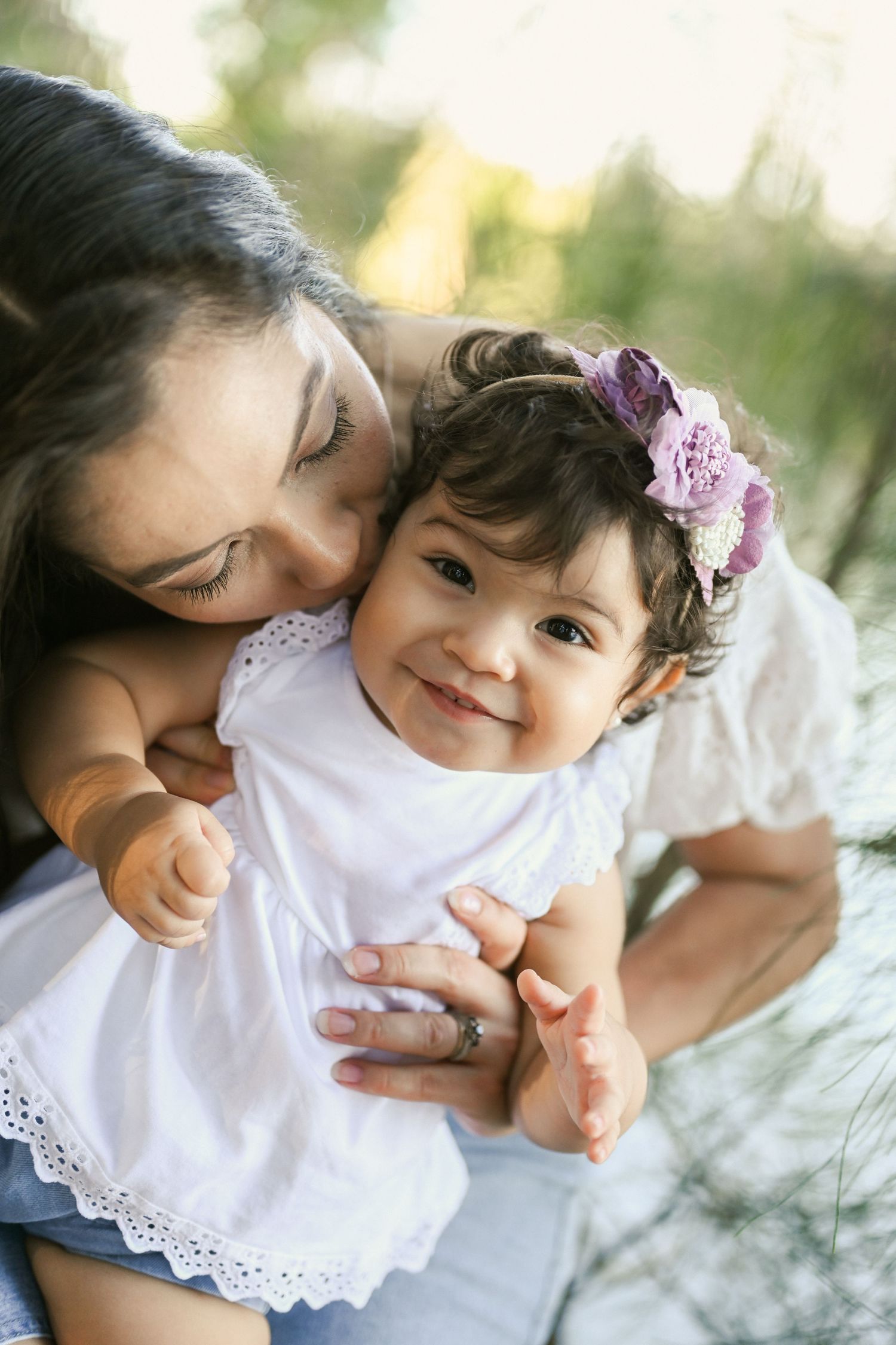 A tender moment captured between parent and child in a series of four sweet outdoor portrait photographs.