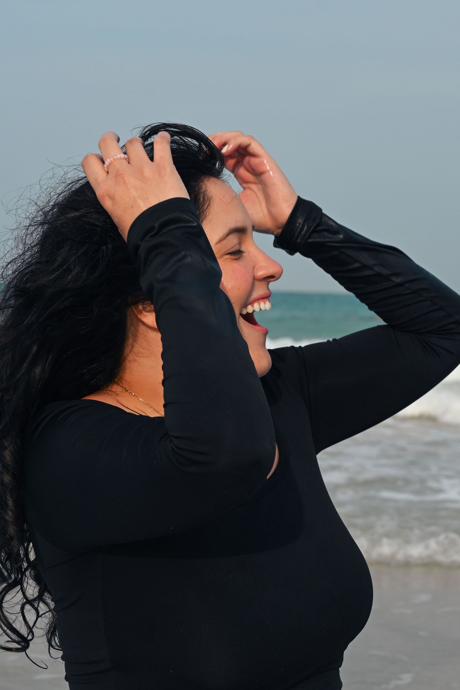 Expressive poses against ocean backdrop showing joyful movement.