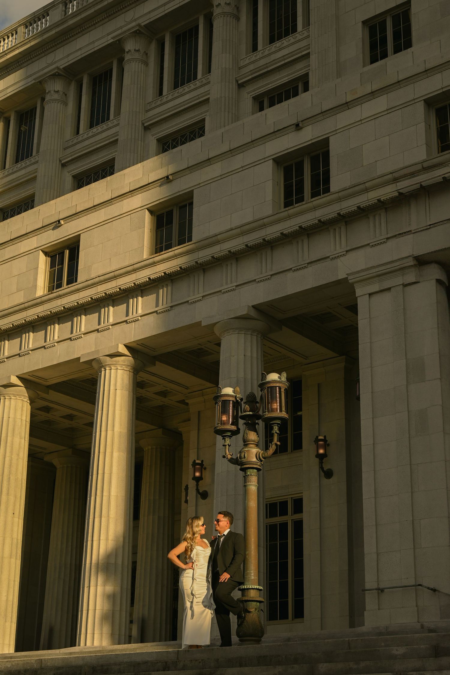 Classical architecture with grand columns creates dramatic shadows in evening light.