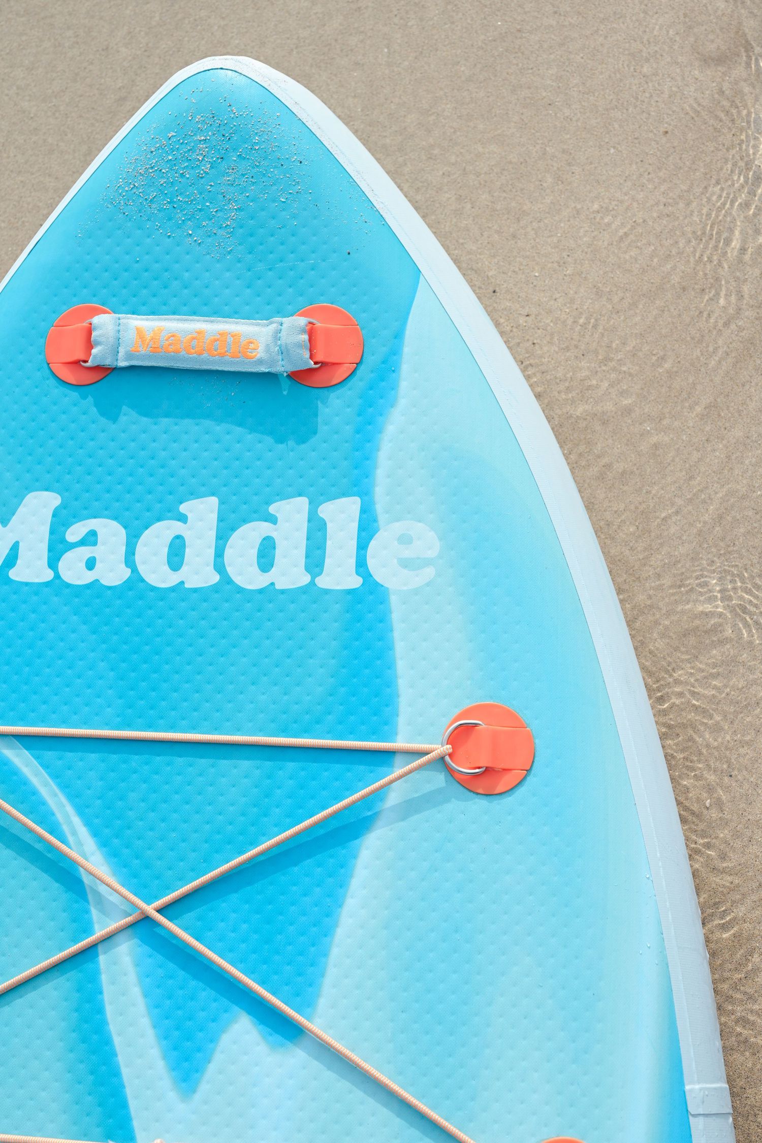 Close-up details of a light blue surfboard showing mounting hardware and texture.