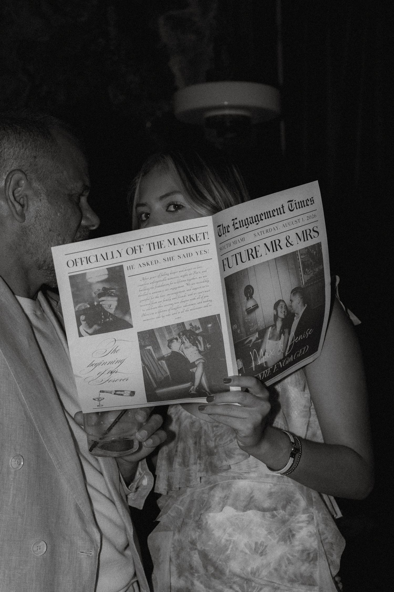 Couple reading The Engagement Times newspaper announcing Future Mr & Mrs at an engagement party celebration.