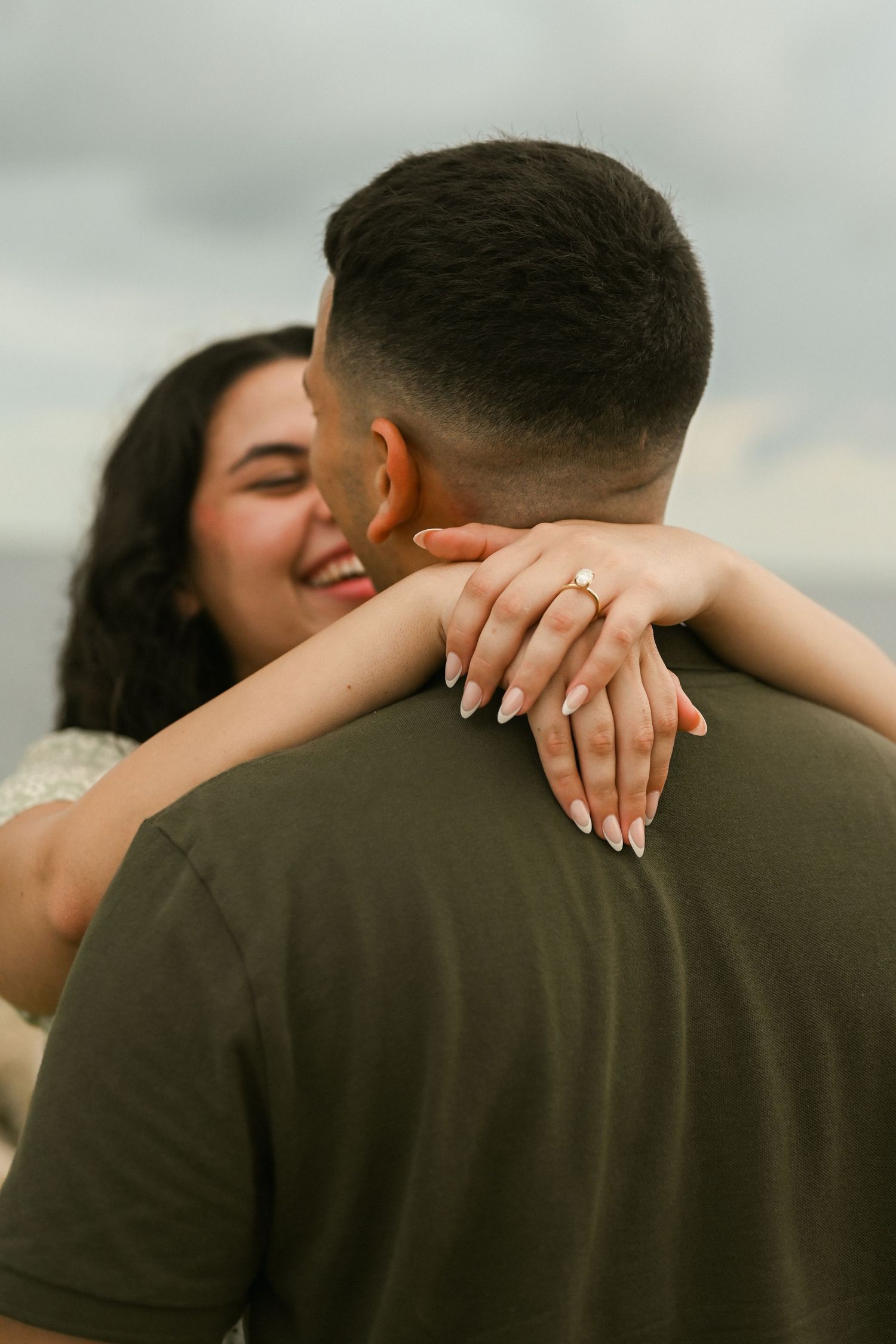 Close-up shot of a couple embracing with focus on hands and gentle touches.
