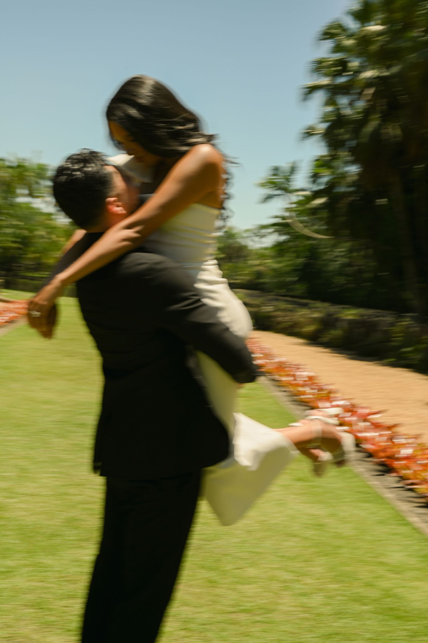 Motion-blurred sequence of a romantic dance spin in an outdoor setting.