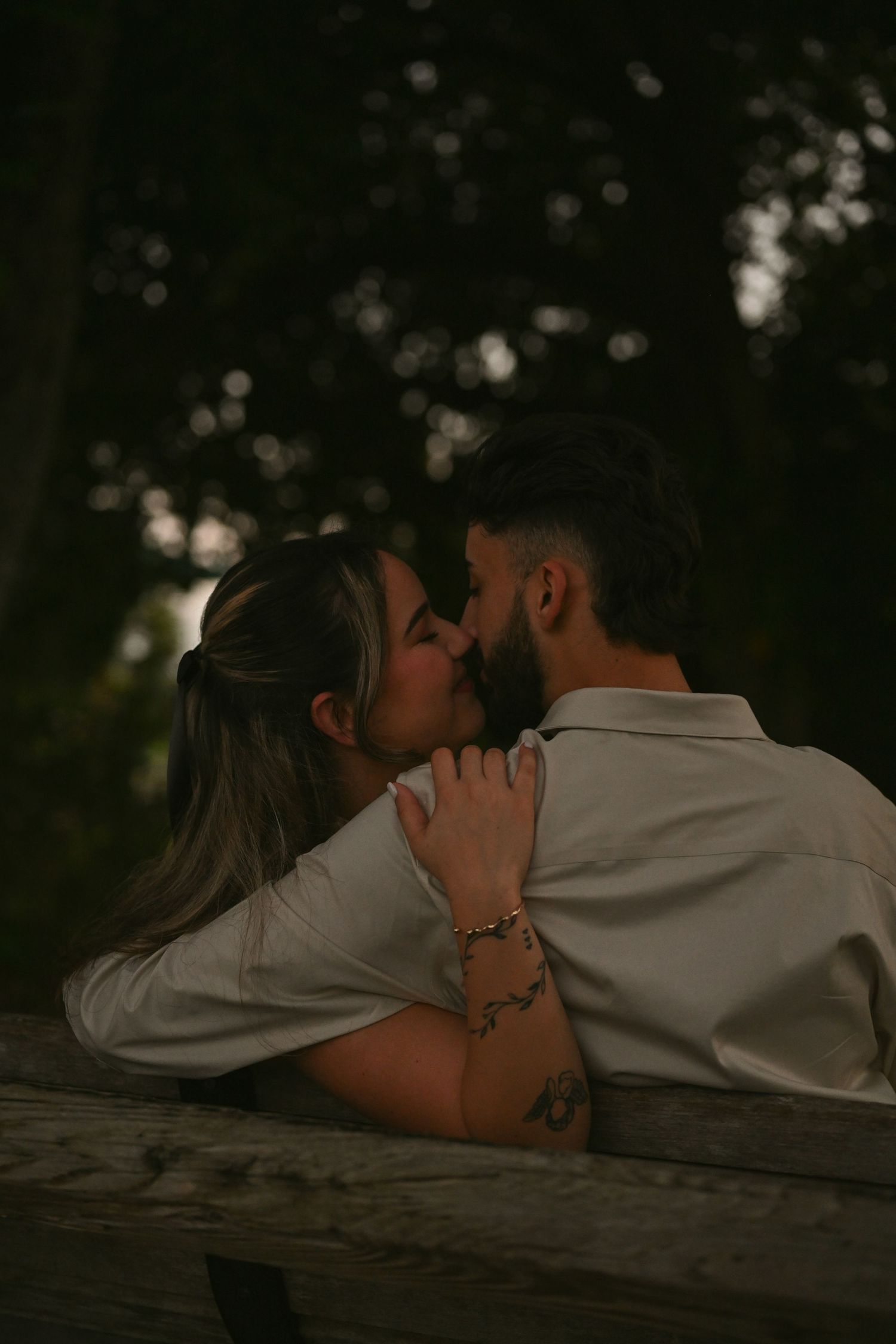 Intimate moment shared on rustic wooden steps at dusk.