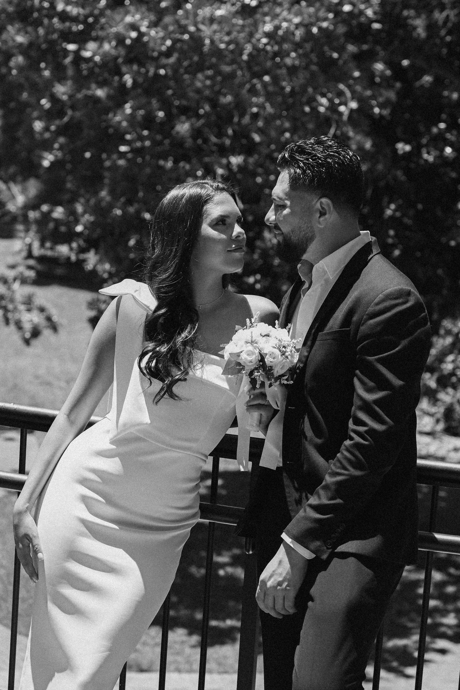 A romantic dance sequence captured in black and white outdoors.