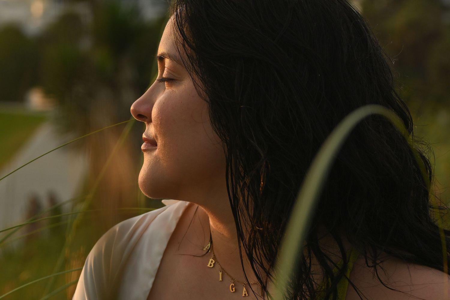 Artistic portrait silhouetted against natural golden sunlight.