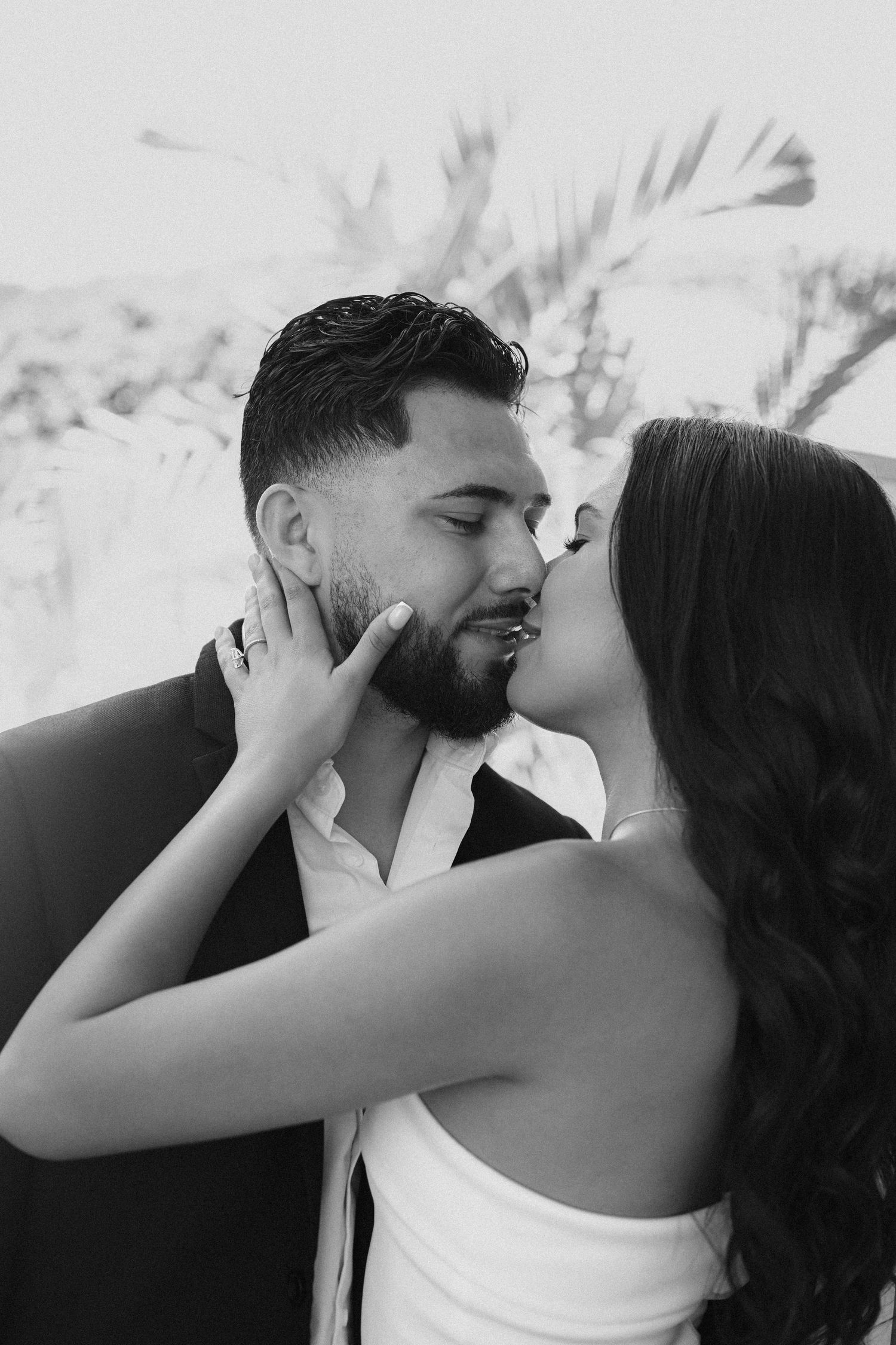 An intimate black and white sequence of a romantic moment outdoors.