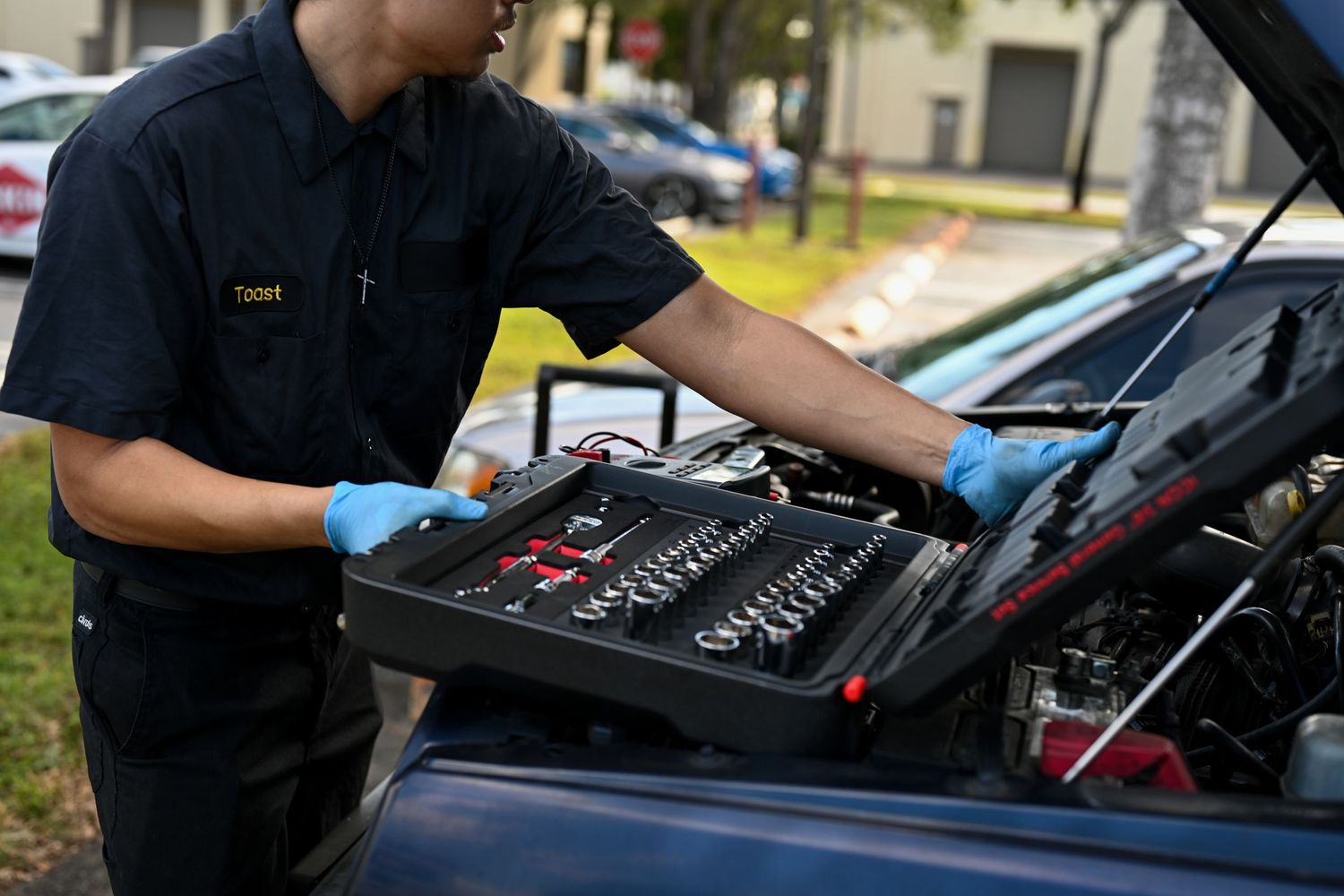 Auto technician conducting engine diagnostics with professional tools.