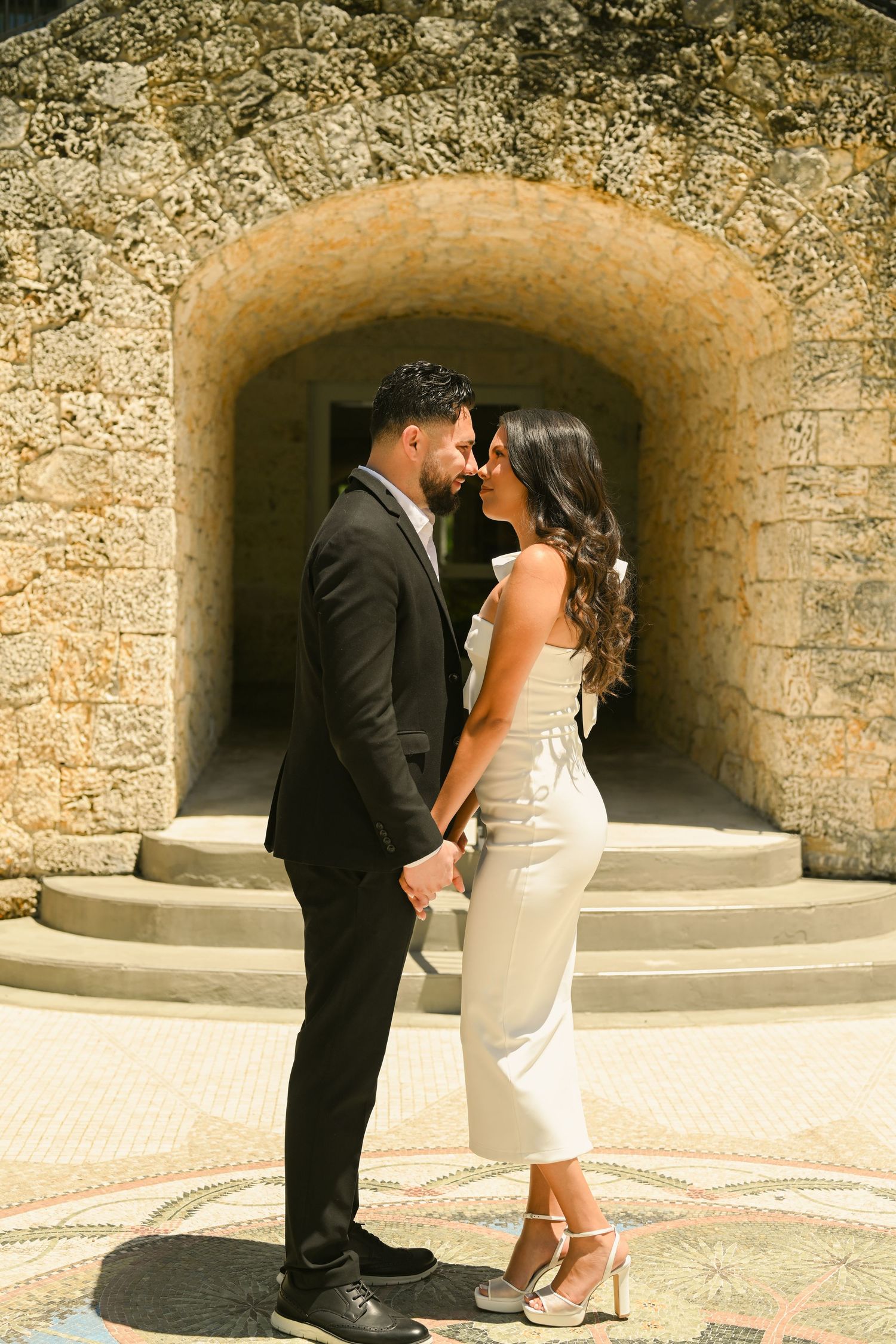 A romantic sequence under a stone archway shows a couple's tender interaction.