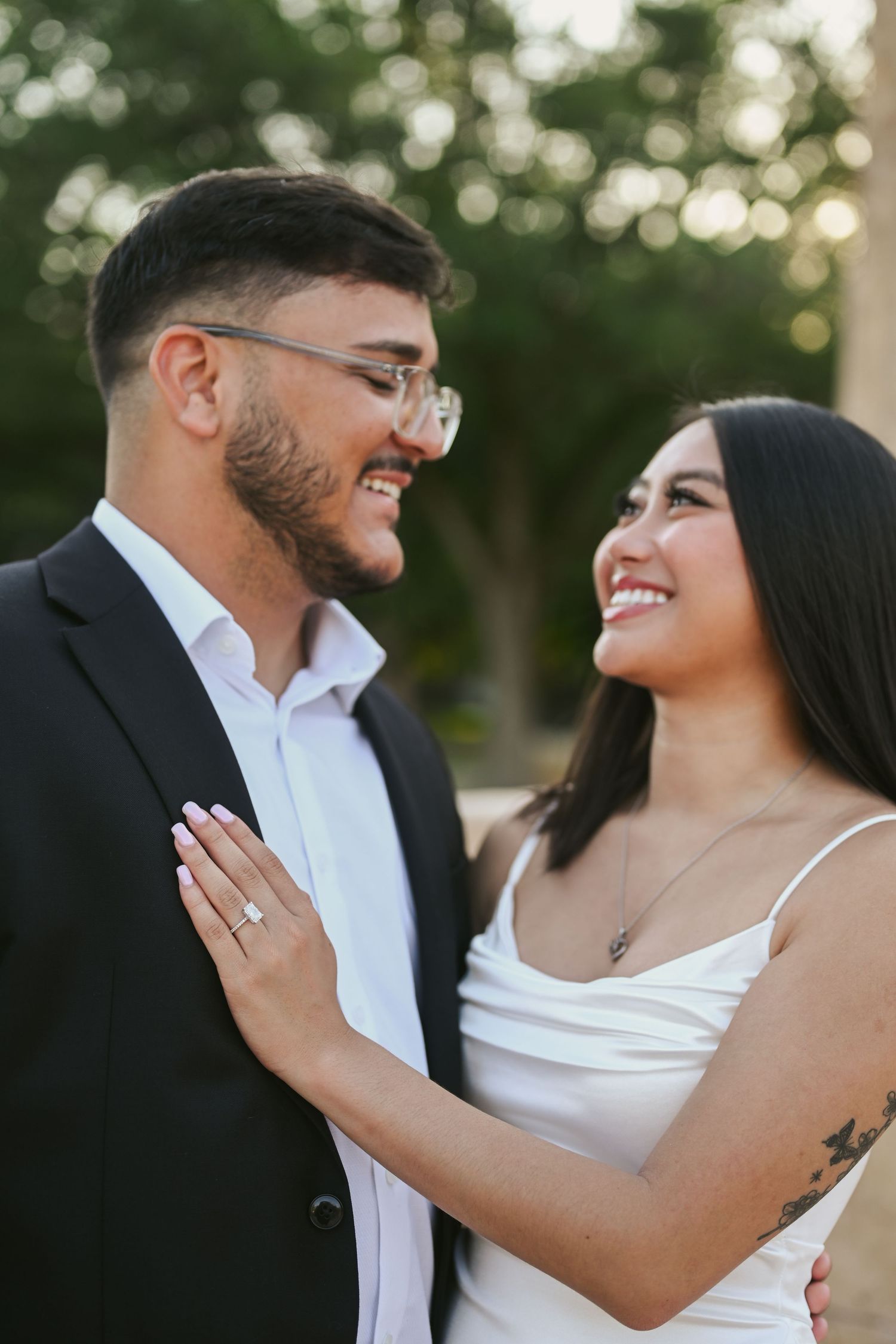 Romantic outdoor photoshoot with couple laughing and showing affection.