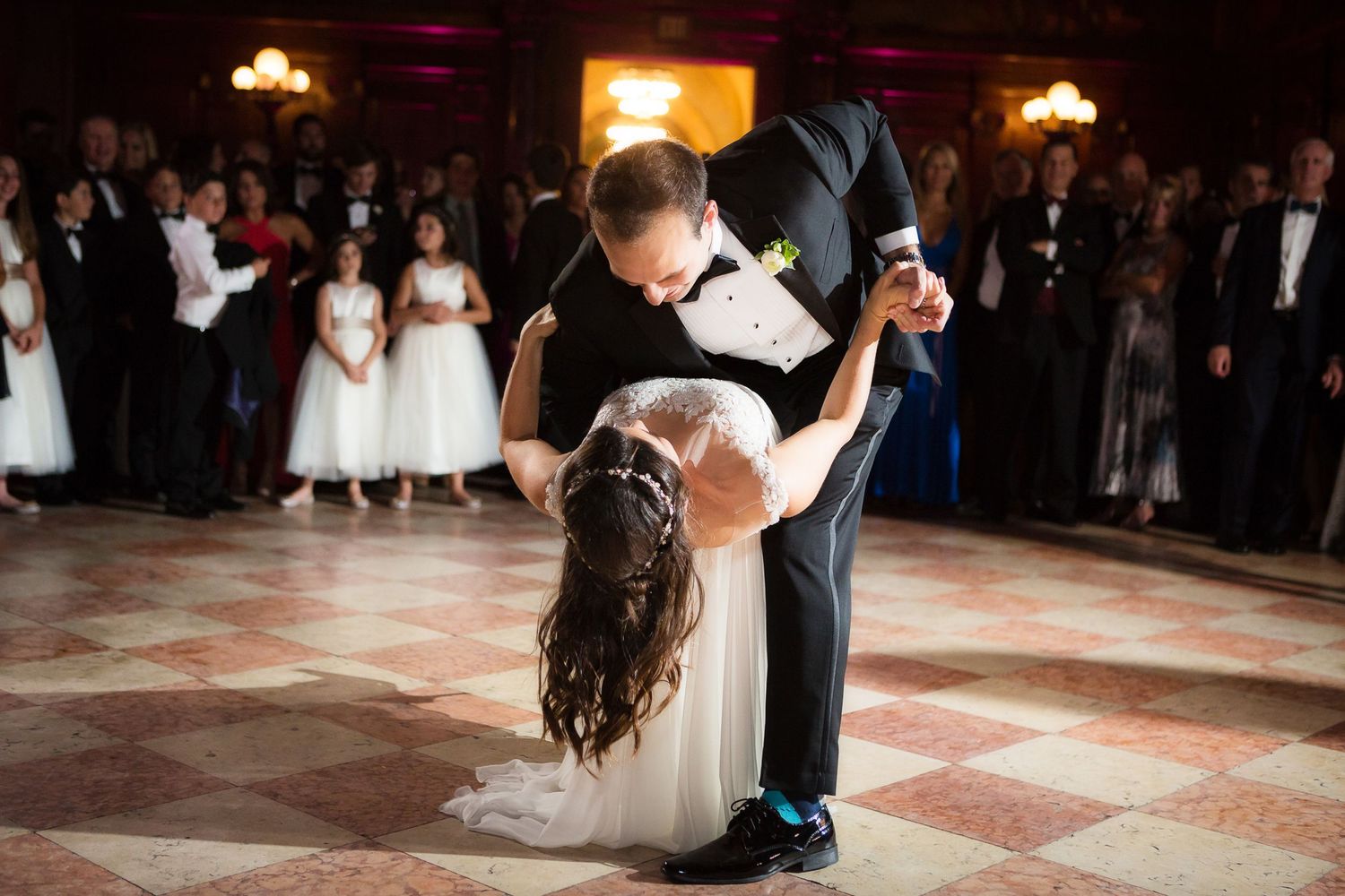 A sequence of wedding dance floor photos showing couples dancing together at a dimly lit reception venue.