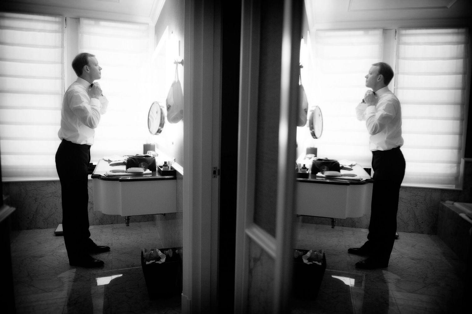 Black and white photo sequence shows a person opening a door and entering a room in progressive steps.