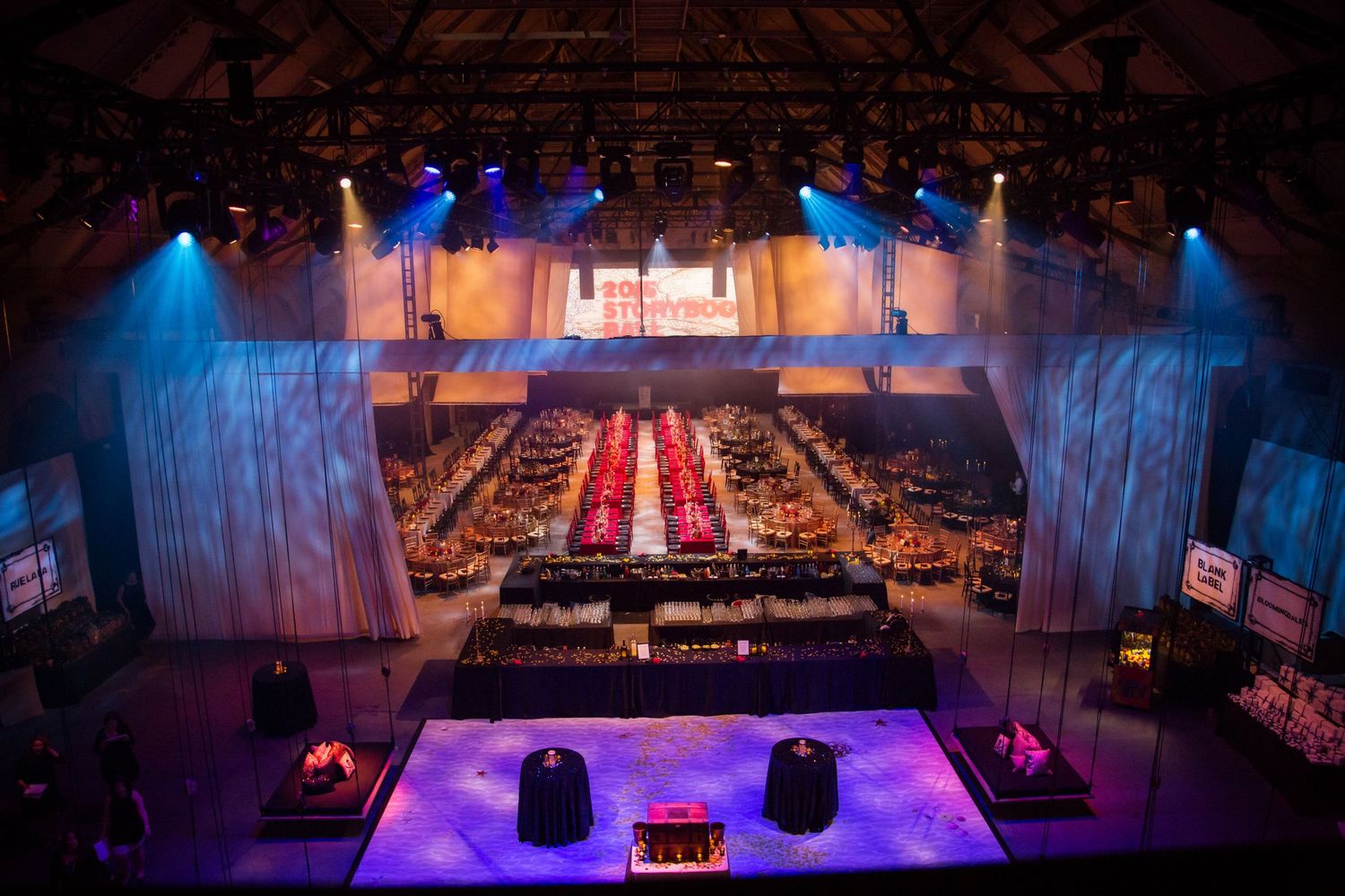 Theater venue with blue and purple stage lighting set up for a grand event.