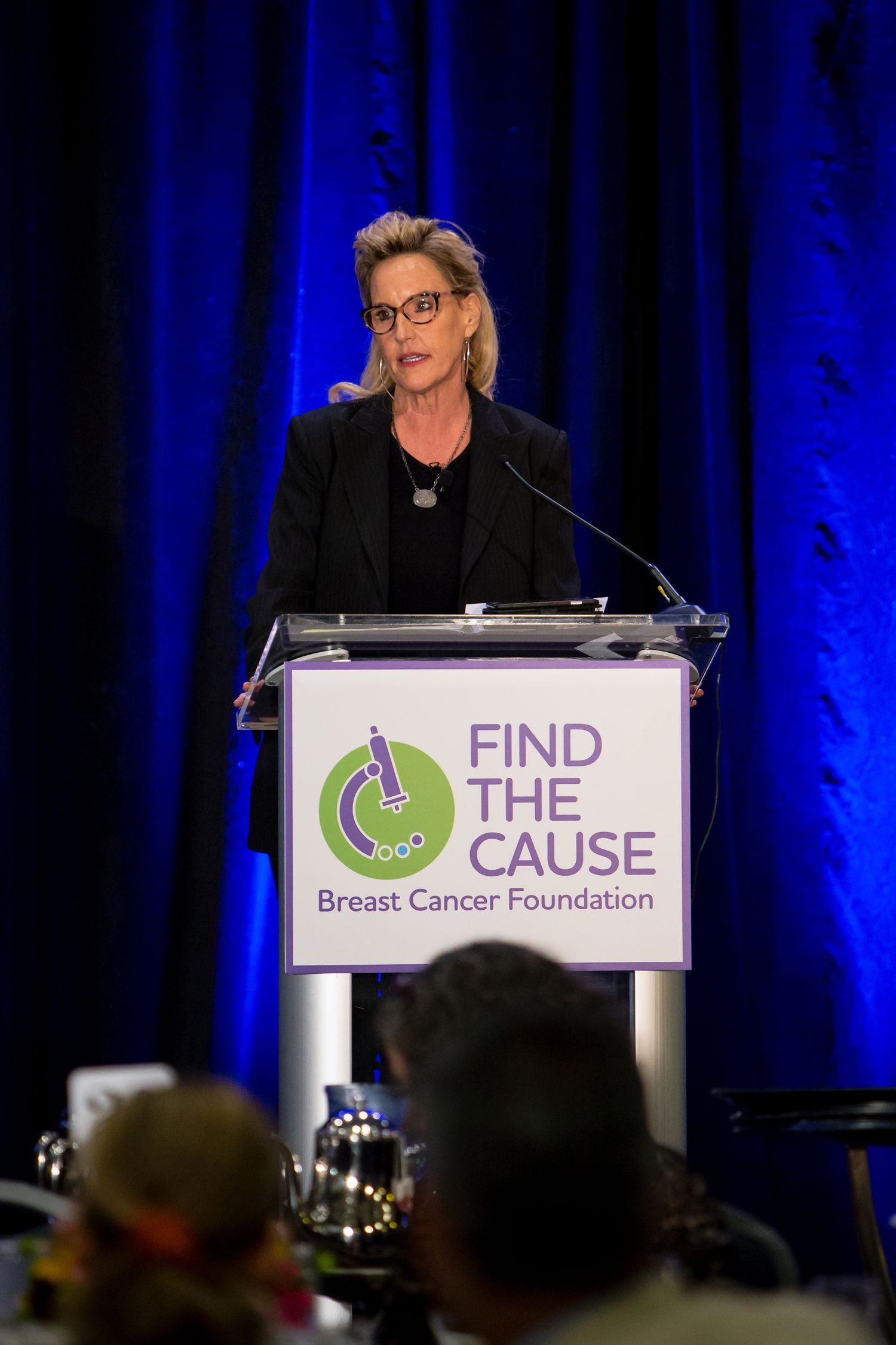 Speaker at podium during Find The Cause Breast Cancer Foundation event.