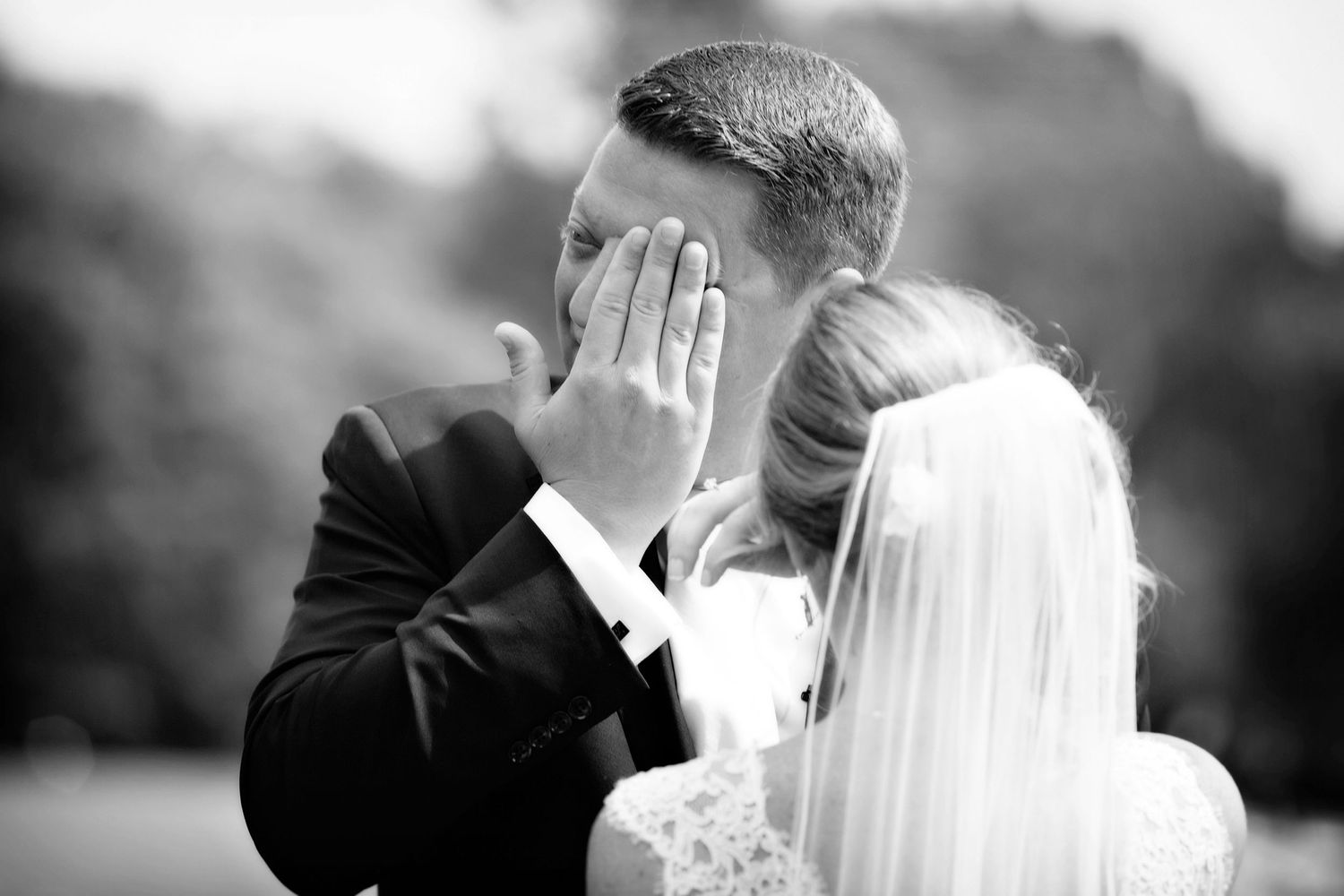 A black and white wedding photo collage showing intimate moments between a bride and groom in formal attire.