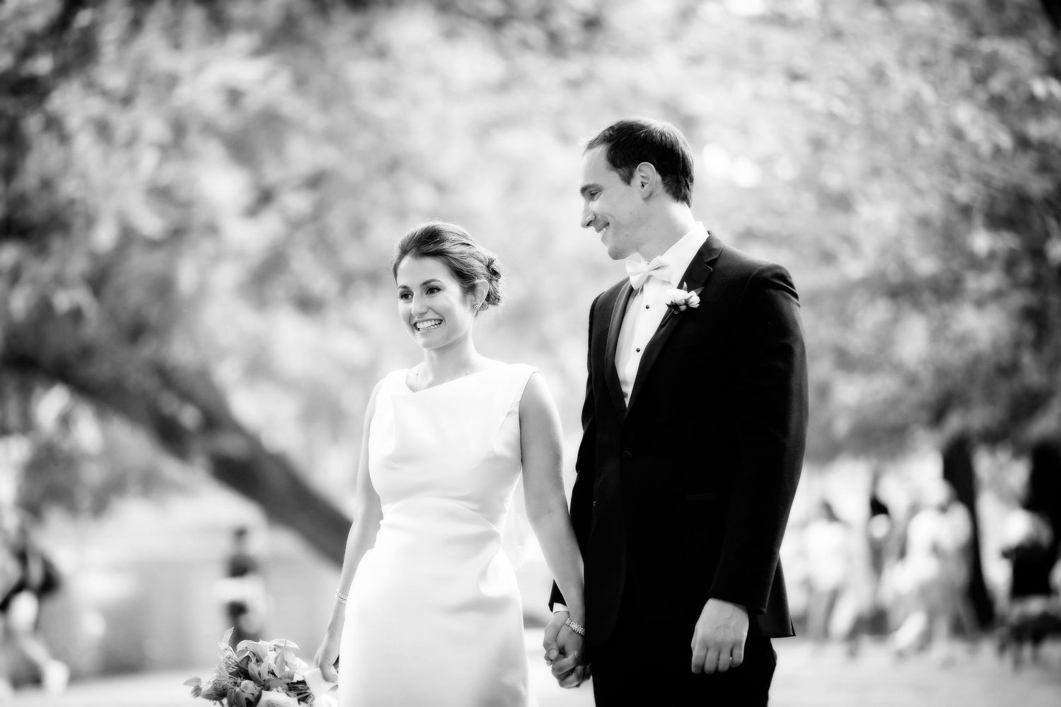 A black and white wedding photo collage showing romantic moments between a couple in an outdoor garden setting.
