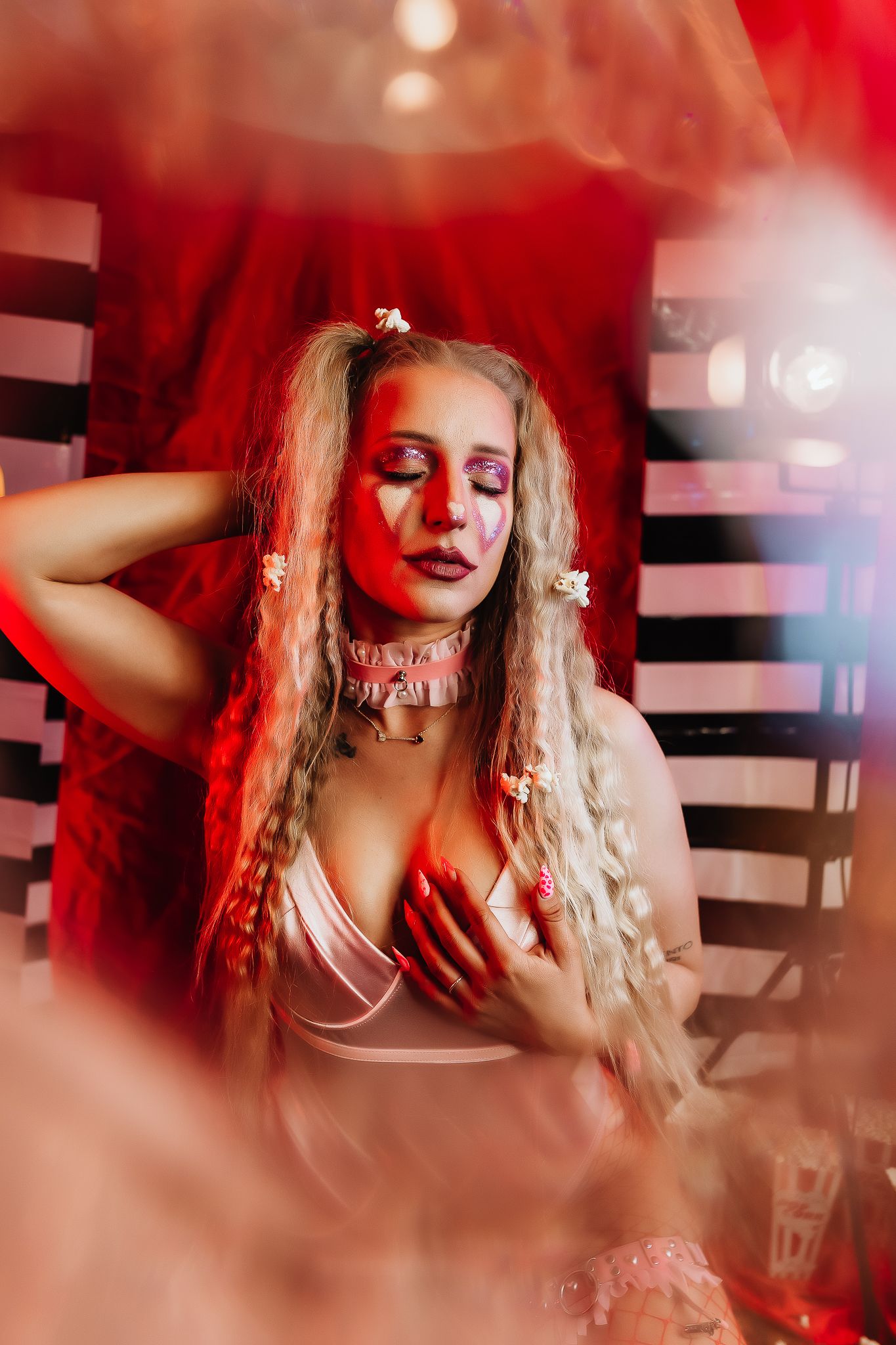 Artistic portrait with red lighting effects and romantic vintage styling.