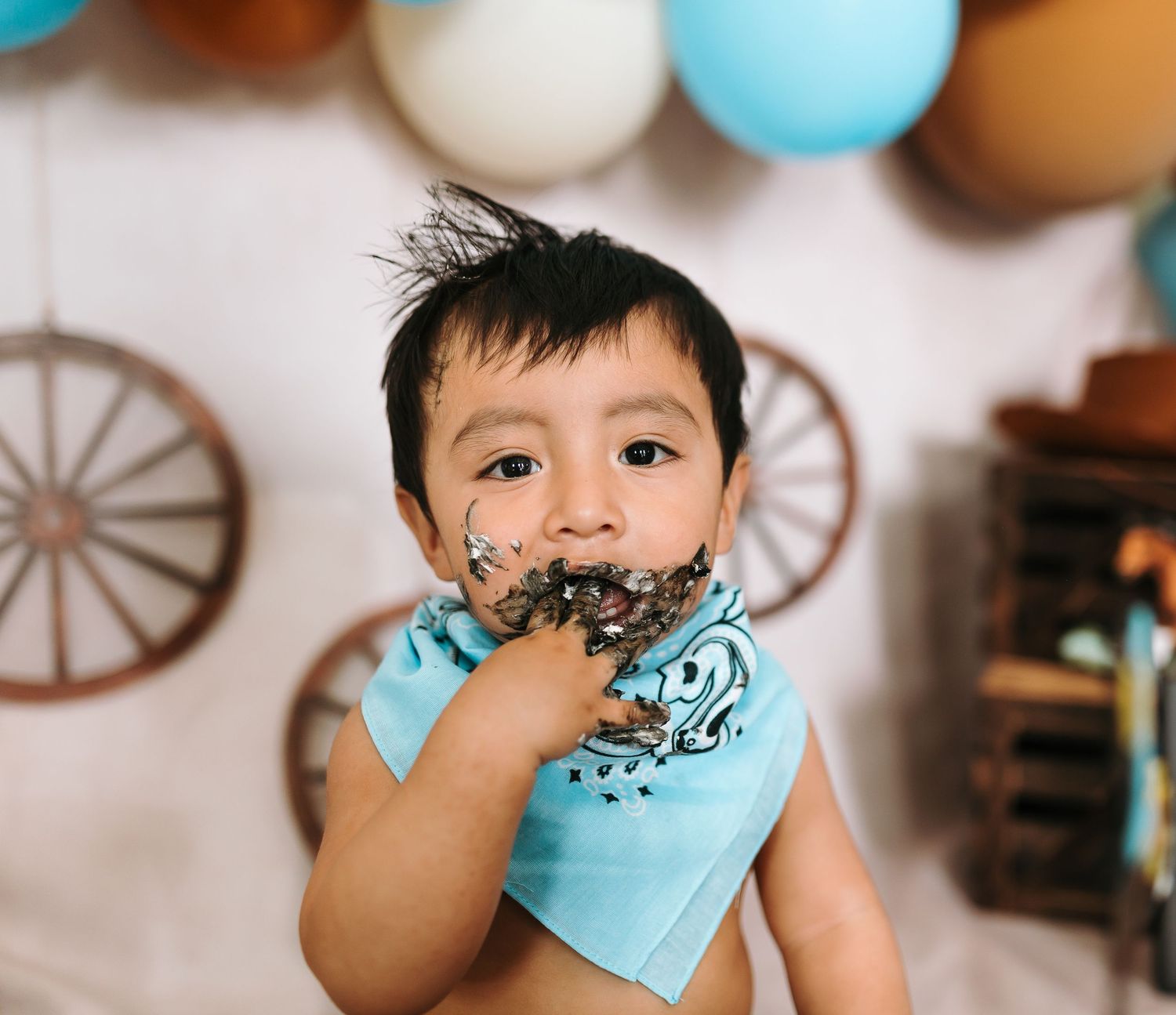 Festive western party scene with decorated backdrop and colorful balloons.