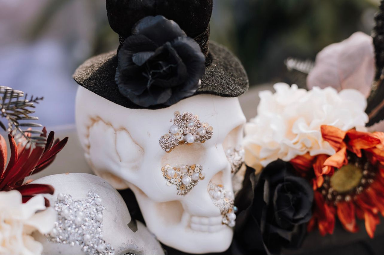 Decorative white skull with black roses for gothic wedding decor.