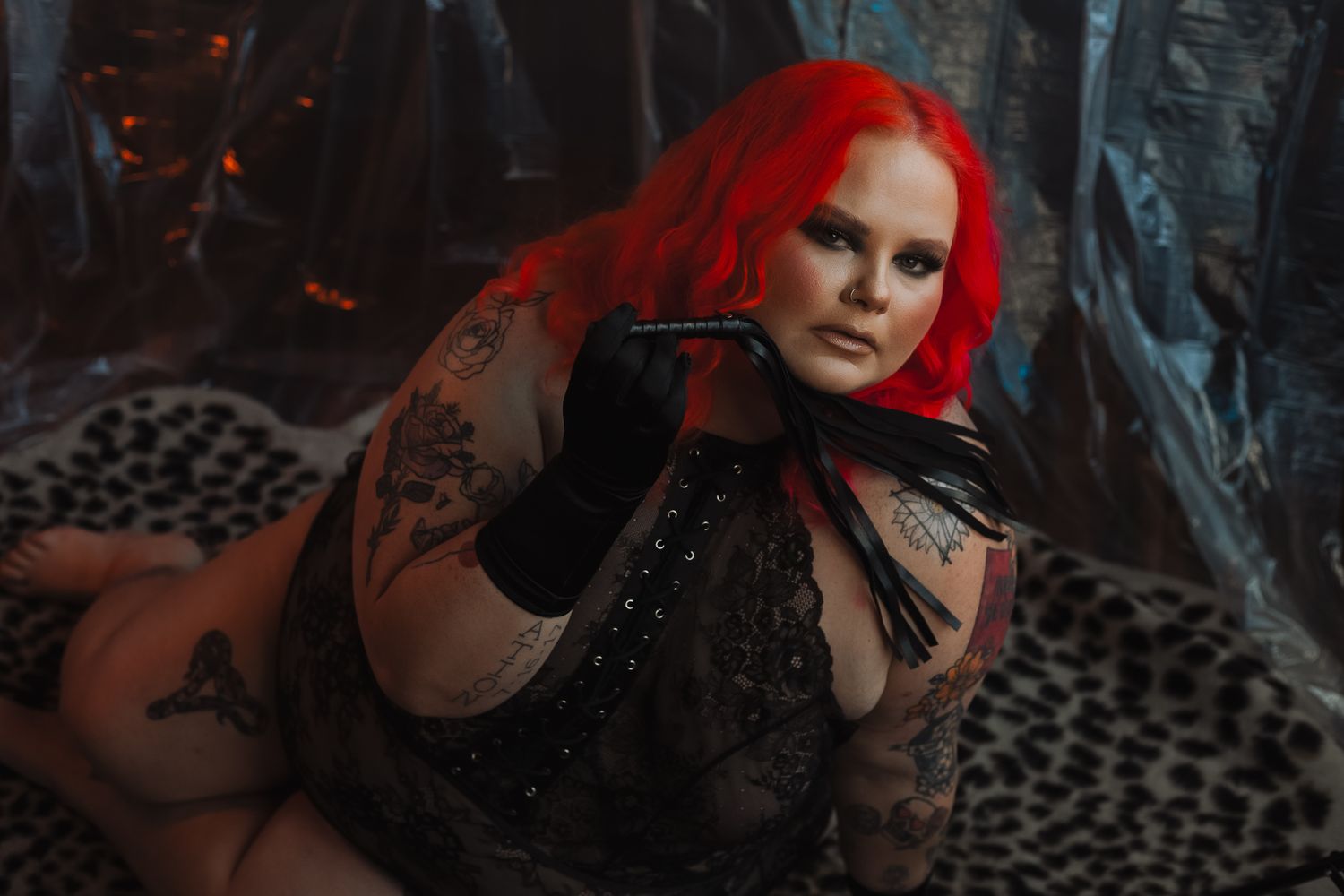 Gothic portrait with vibrant red hair and black lace against dark background.