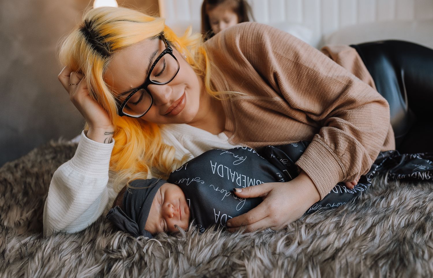 A cozy scene on gray fur blanket showing gentle moment of rest and connection.