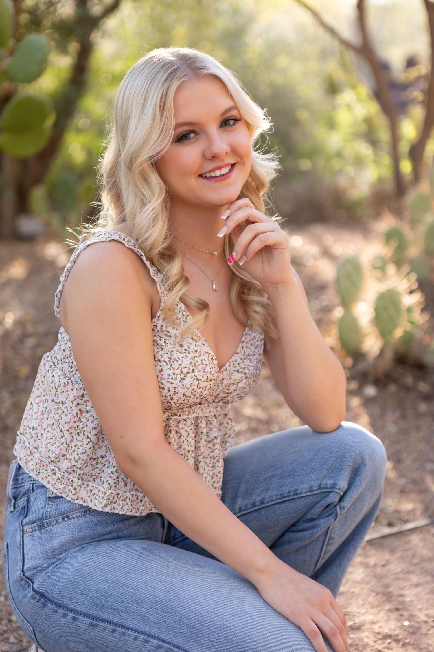 High school senior girl smiling during outdoor photo session in Desert Botanical Gardens