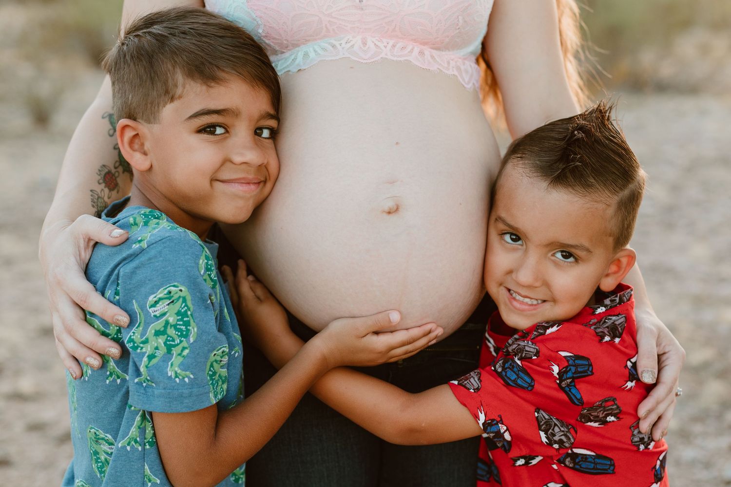 Outdoor maternity photo shoot near Phoenix with cactus and mountain views