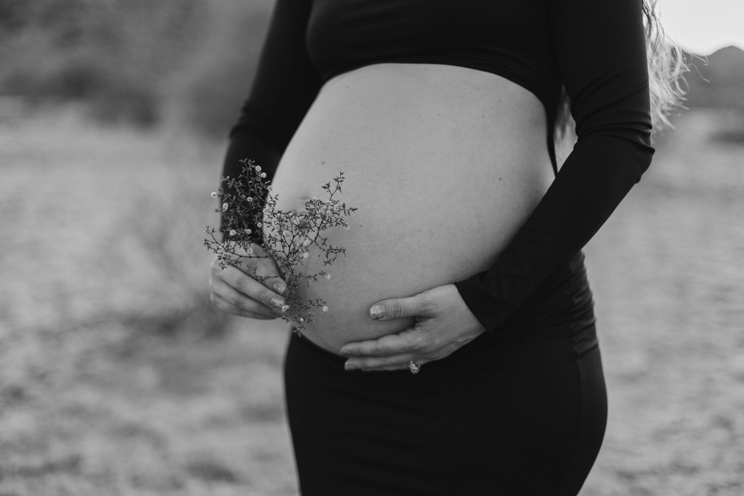 Outdoor maternity photo shoot near Phoenix with cactus and mountain views