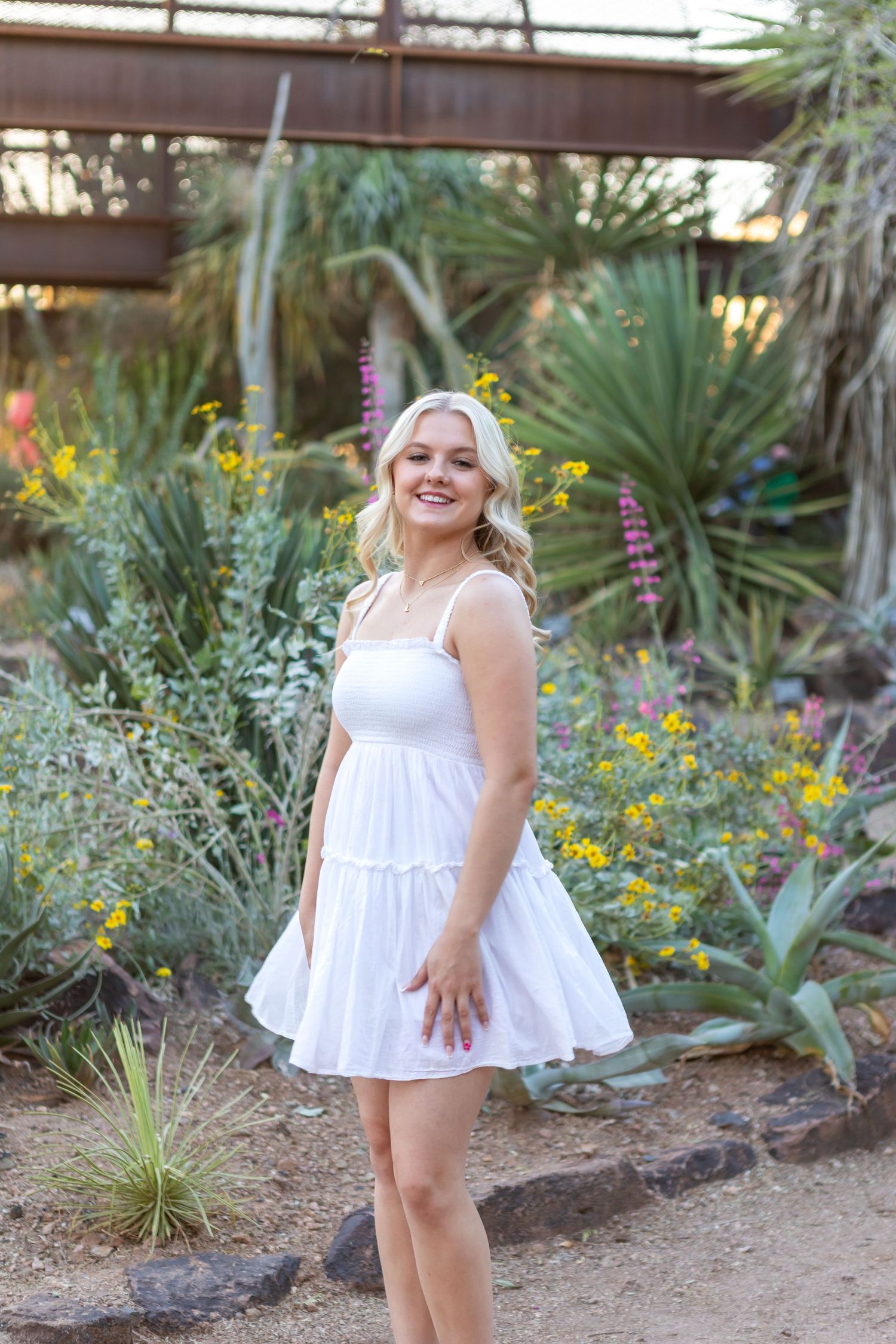 High school senior girl smiling during outdoor photo session in Desert Botanical Gardens