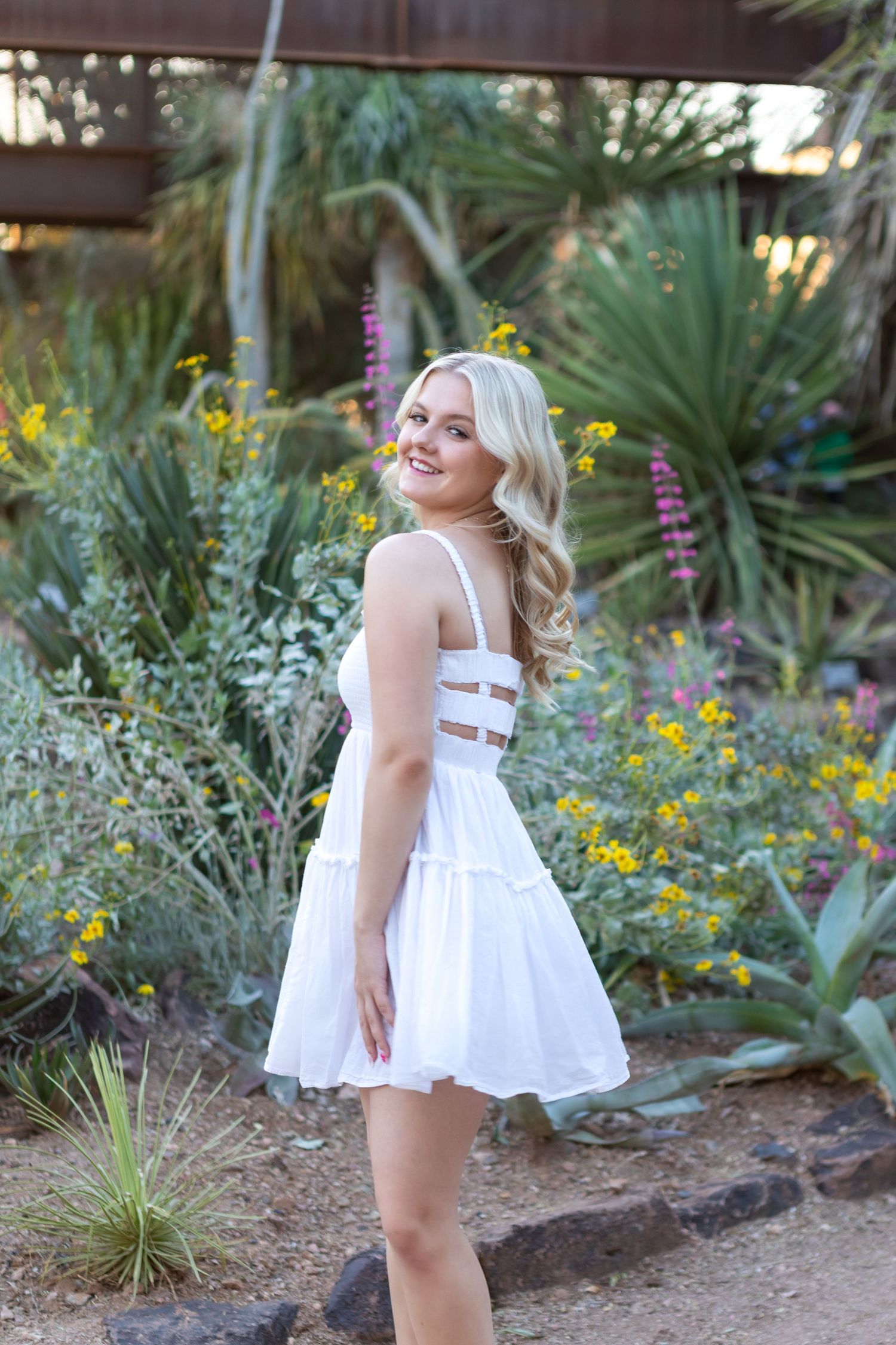 High school senior girl smiling during outdoor photo session in Desert Botanical Gardens