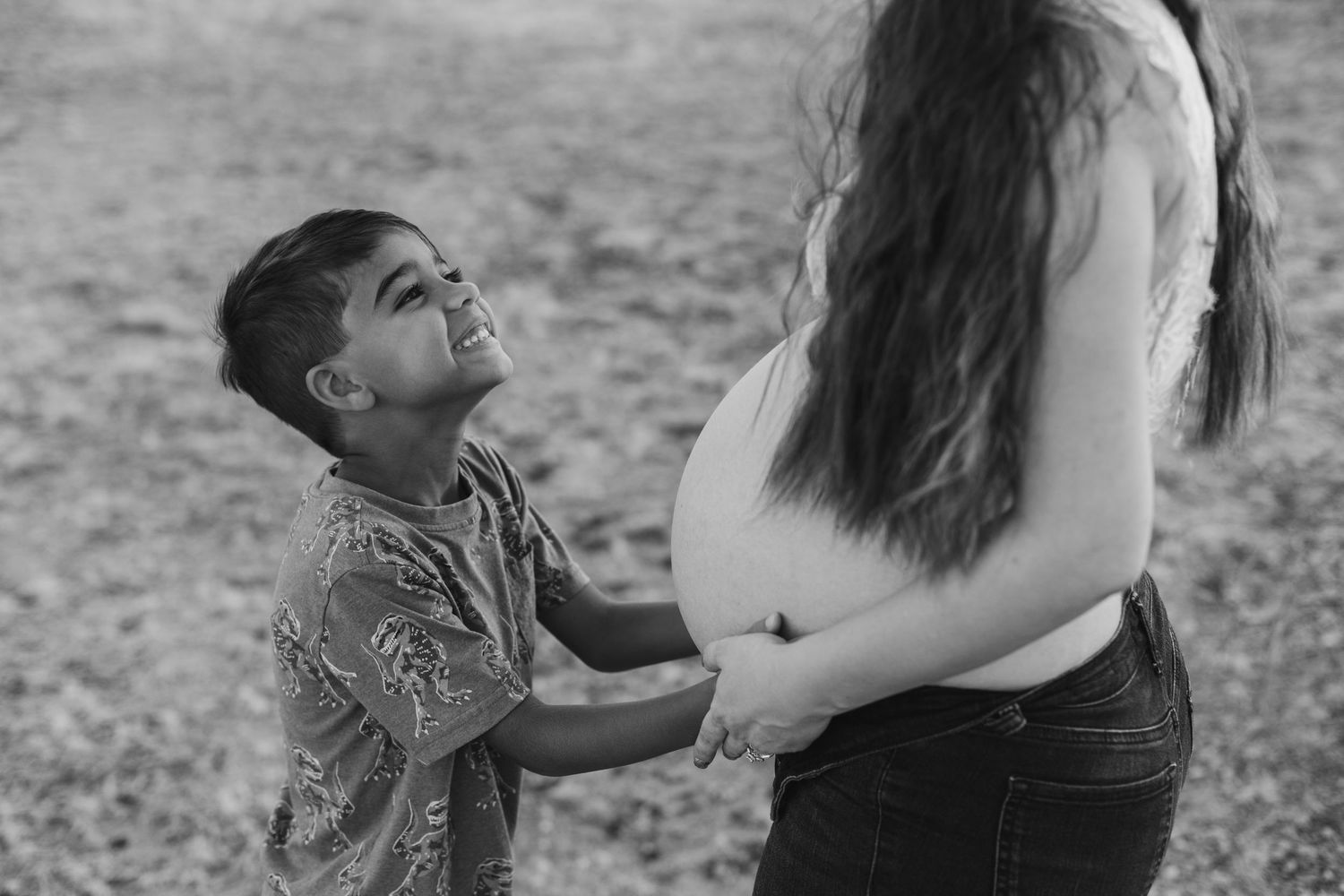 Outdoor maternity photo shoot near Phoenix with cactus and mountain views