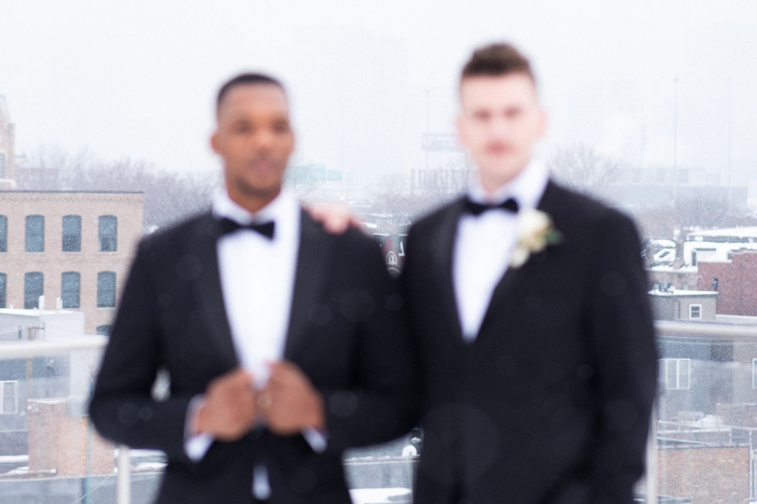 A gay couple stop for a photo on their wedding day.