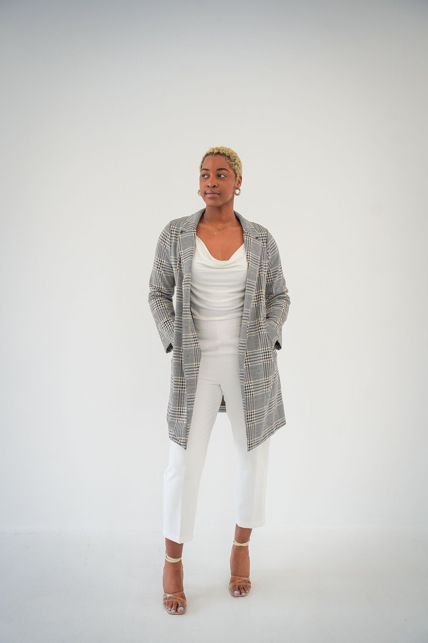 Monaco Media. Professional fashion portraits in gray plaid blazer and white outfit against light background.