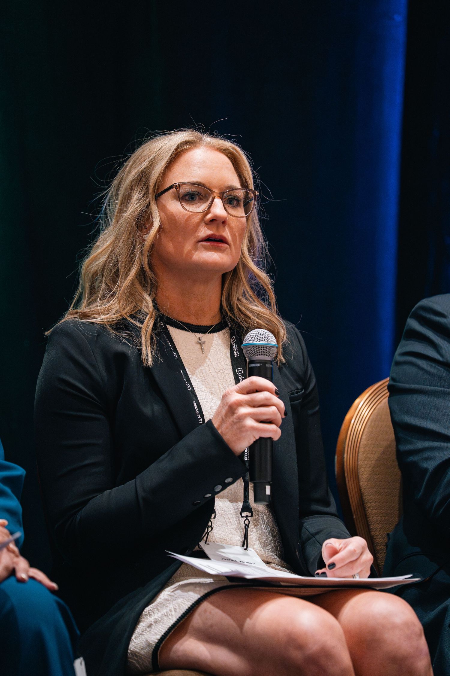 Professional speaker engaging audience during conference presentation.