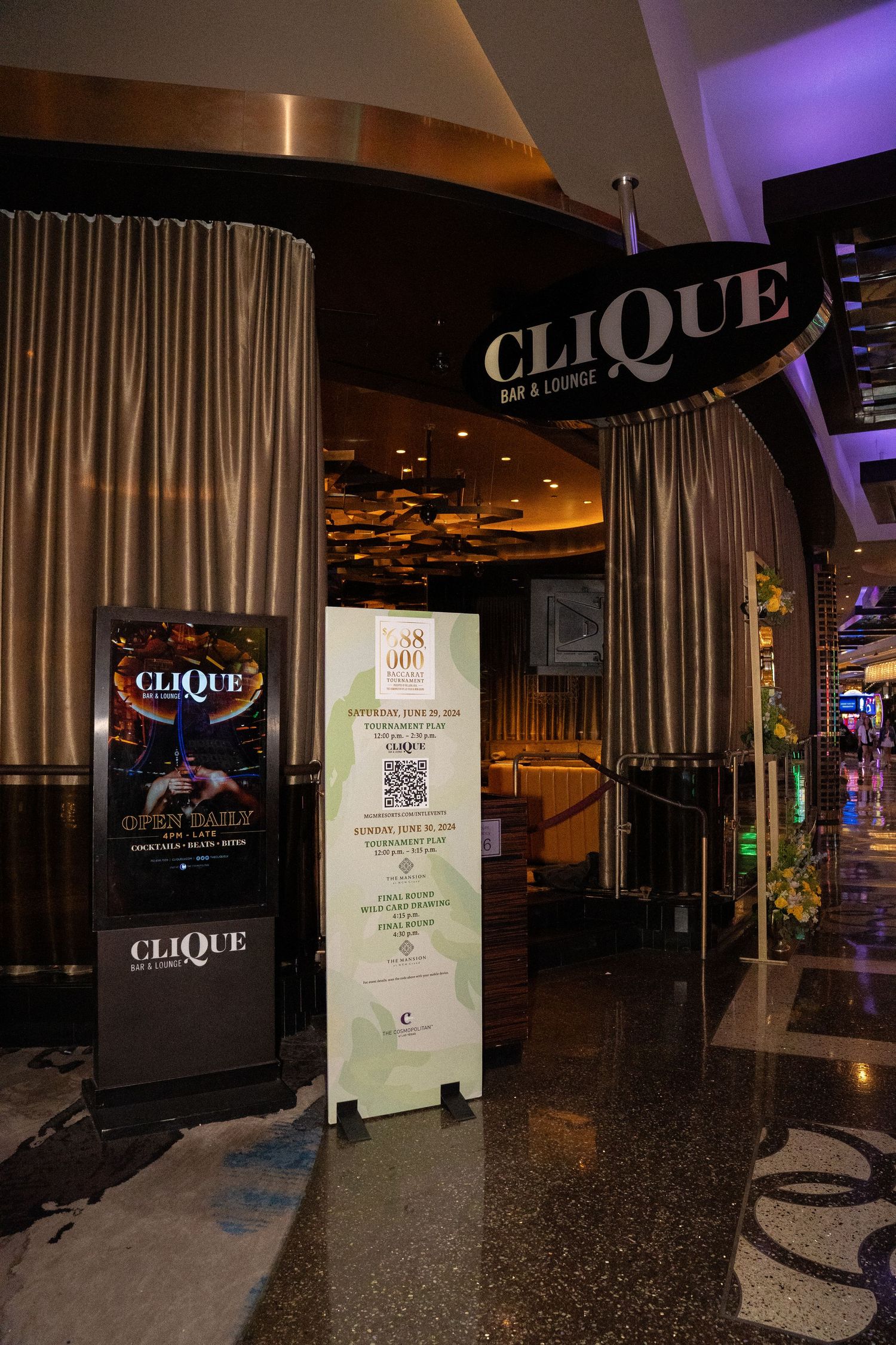Clique nightclub entrance with digital displays and modern curtain design.