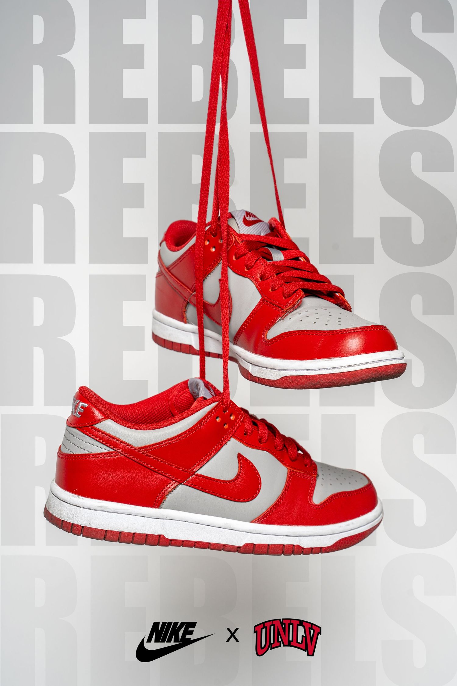 Red and white Nike x UNLV sneakers displayed against a grey background with repeating REBELS text.
