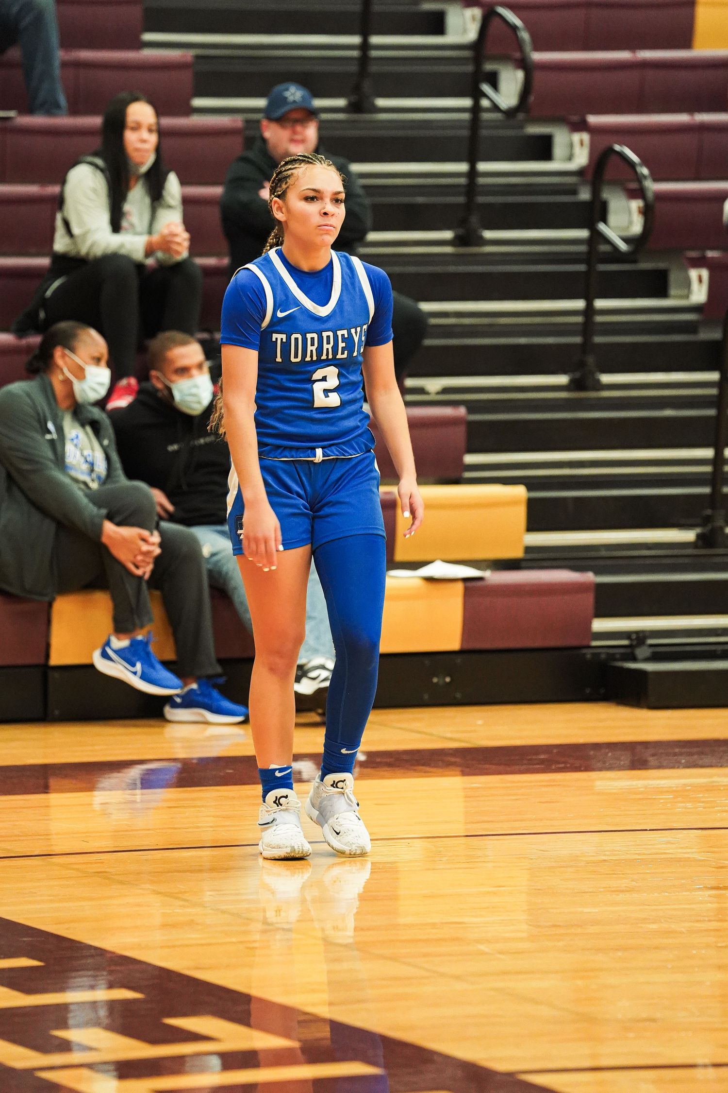 Basketball player in blue uniform standing on court during game.