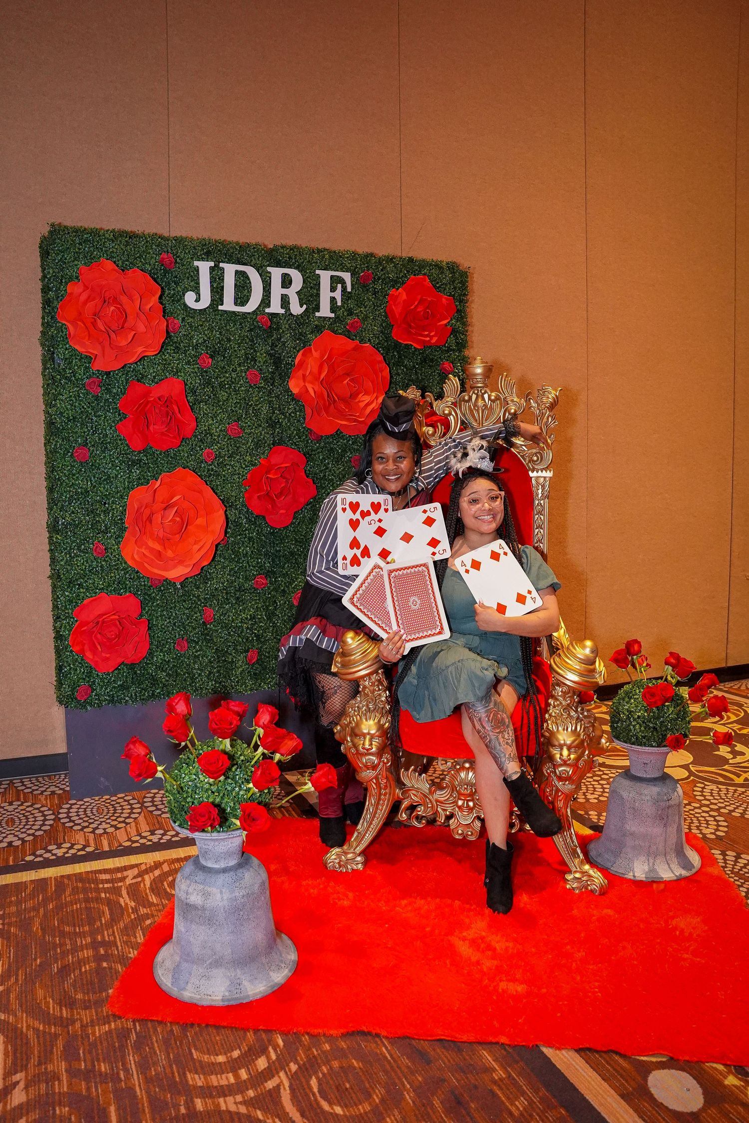 Decorative photo setup with JDRF backdrop featuring red roses and ornate gold throne.