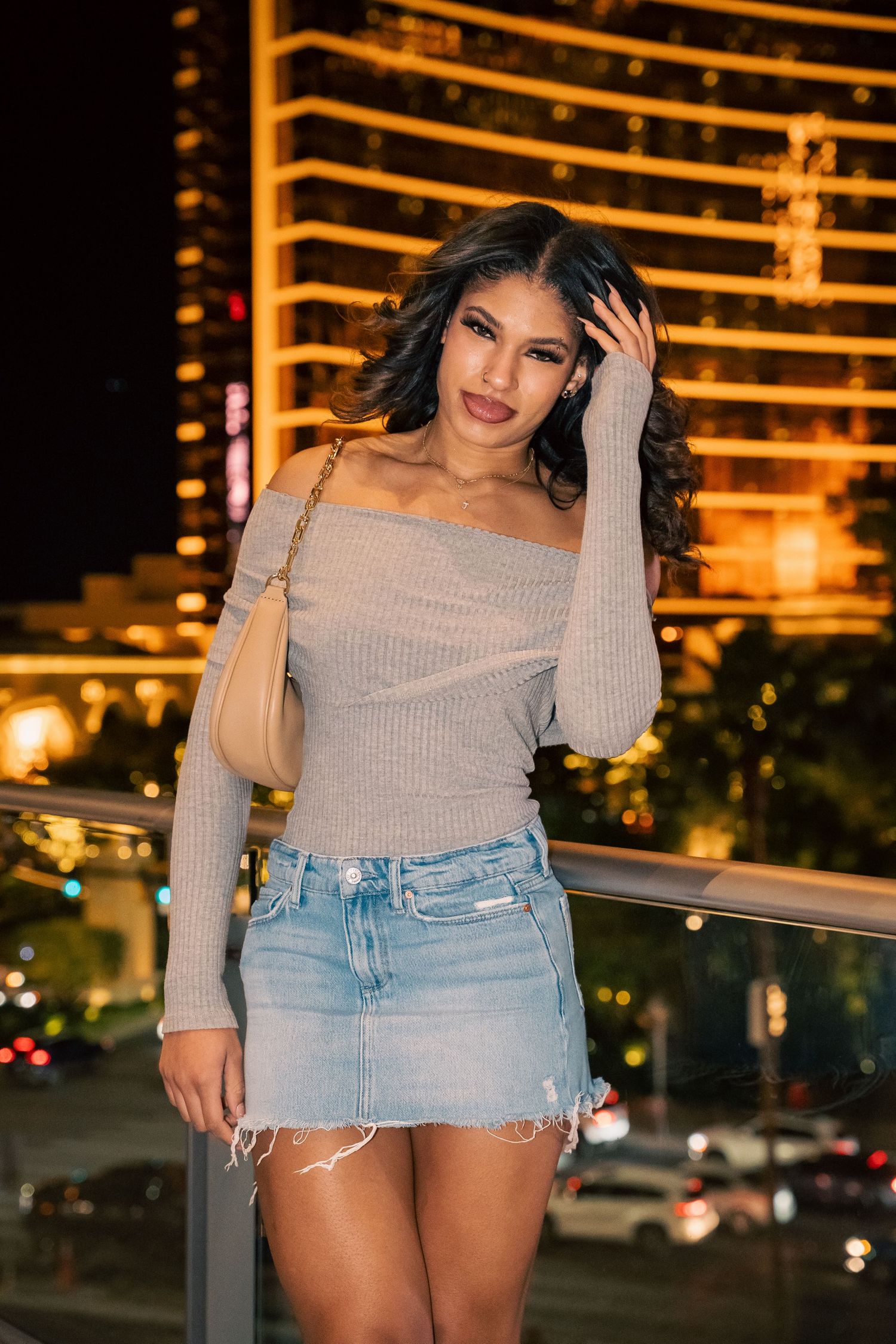 Outdoor fashion portrait with illuminated Las Vegas resort in background.