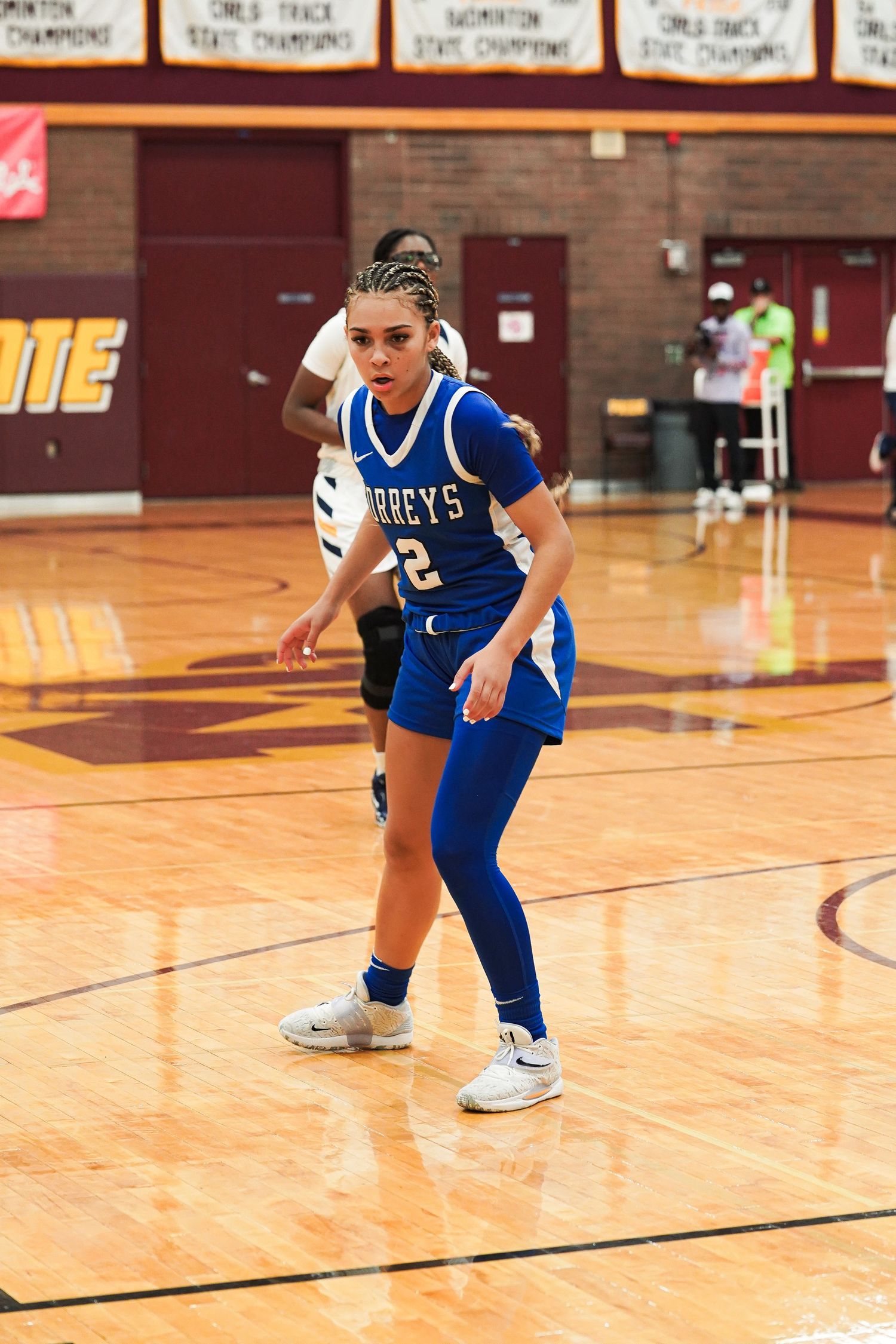 Player in blue Torreys uniform dribbling basketball during game.